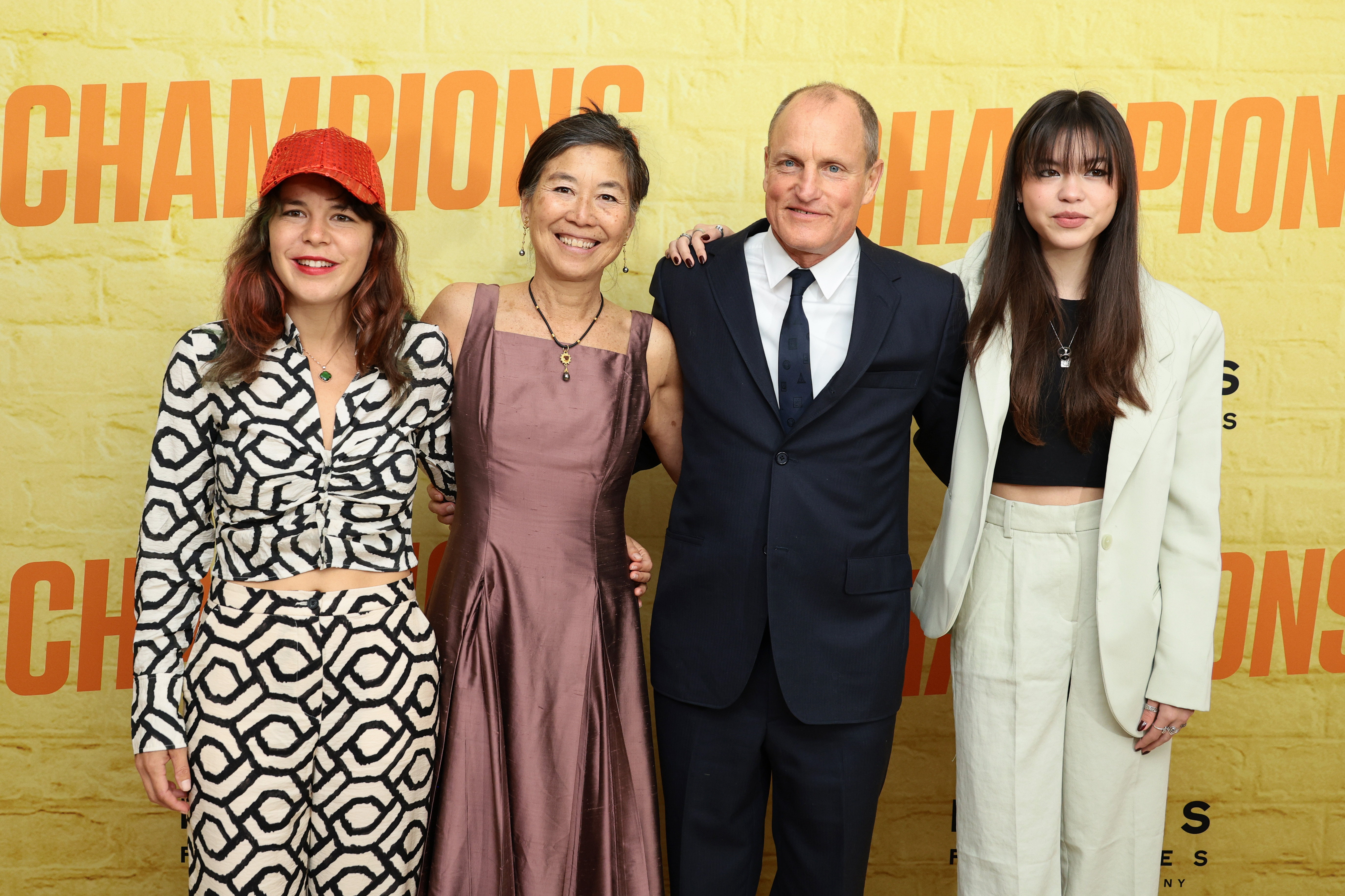 Laura Louie and Woody Harrelson with their two daughters, Deni and Makani Harrelson, at the premiere of "Champions" on February 27, 2023, in New York City | Source: Getty Images