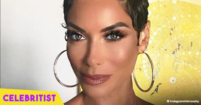 Nicole Murphy shows off her toned body in black cut-out swimsuit