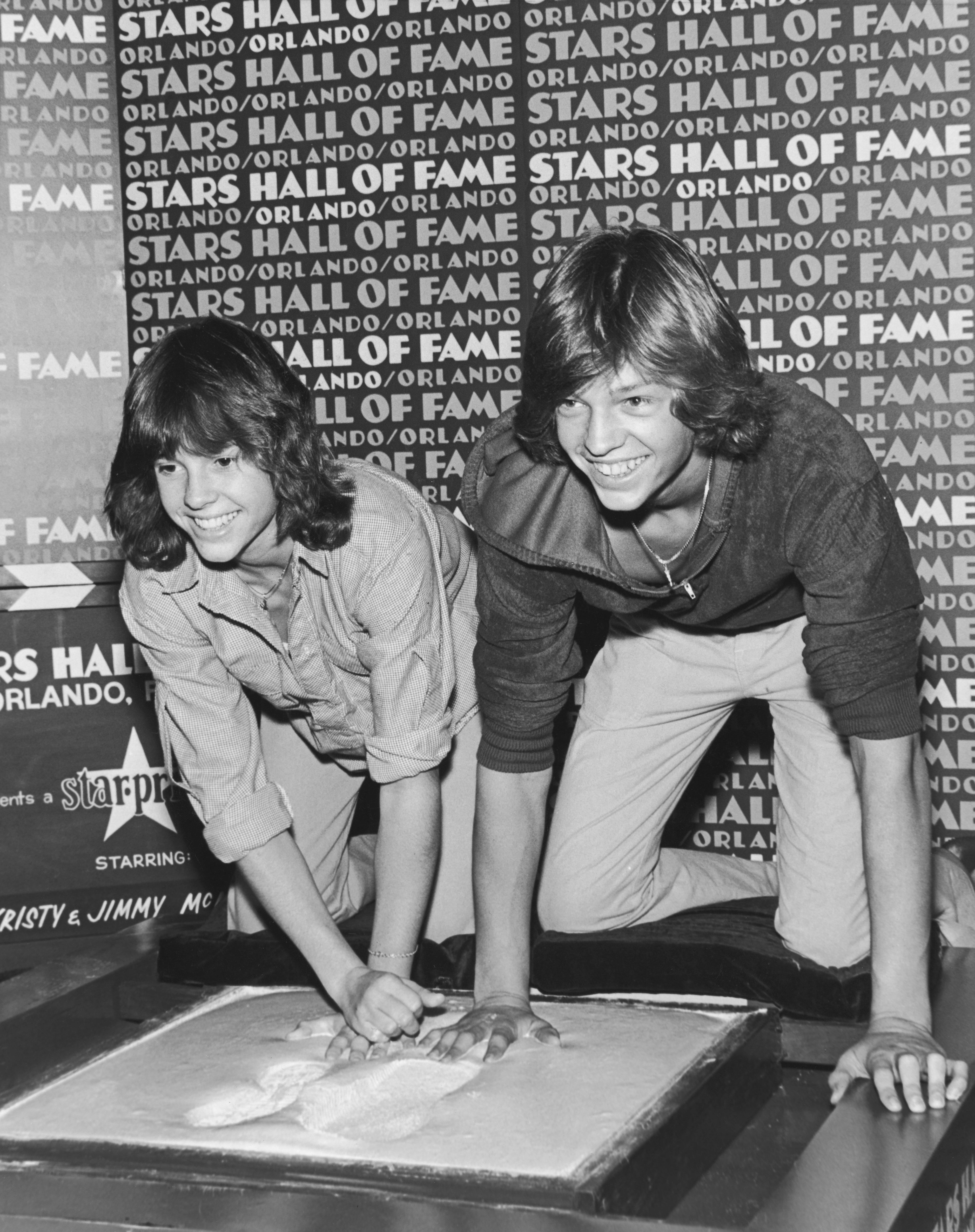 Kristy McNichol and her brother, Jimmy, set their footprints and handprints in wet cement at the Stars Hall of Fame in Orlando, Florida, circa 1979. | Source: Getty Images