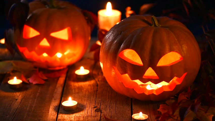 Halloween pumpkin head jack lantern with burning candles | Shutterstock.com