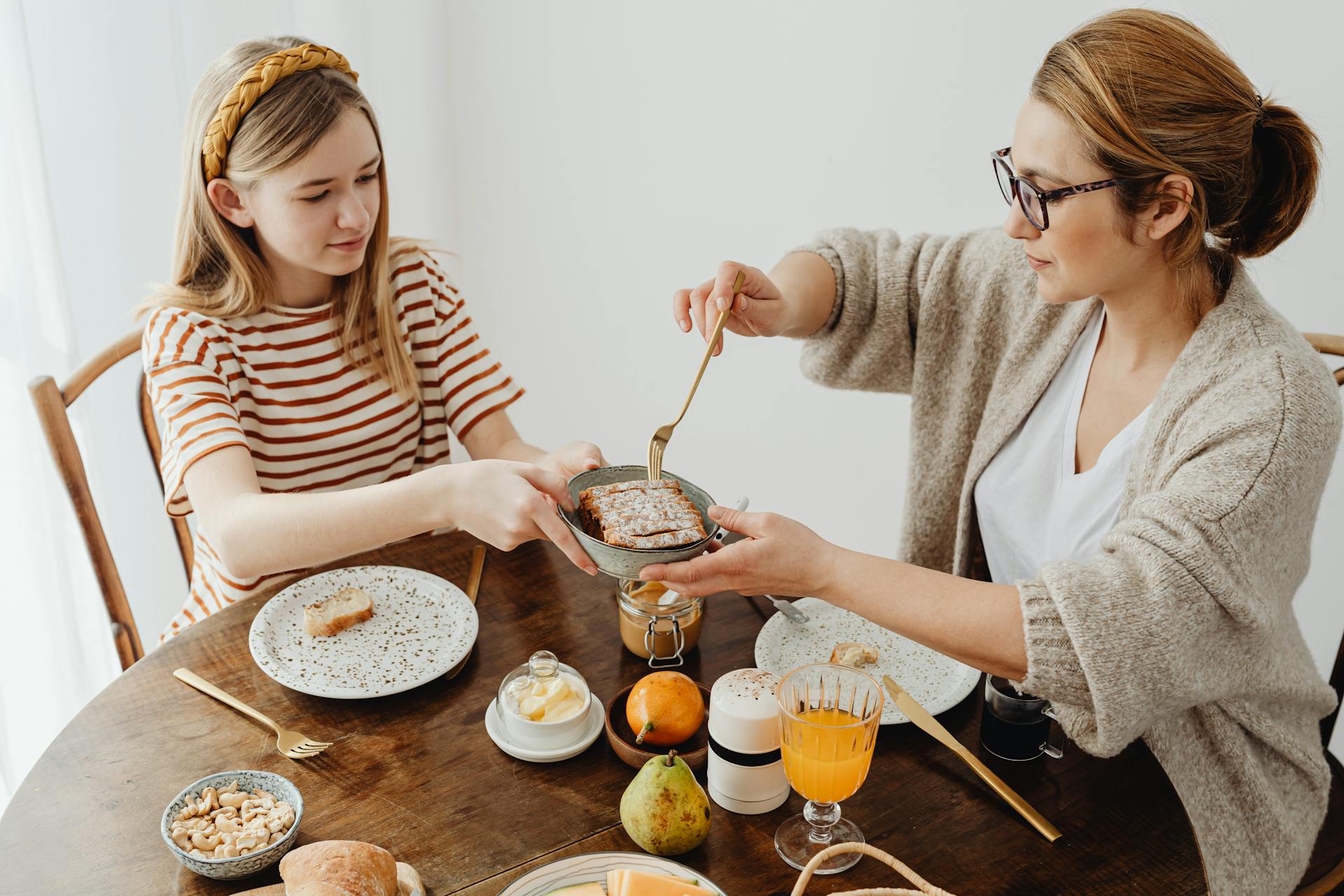 A woman with her daughter in the dining room | Source: Pexels