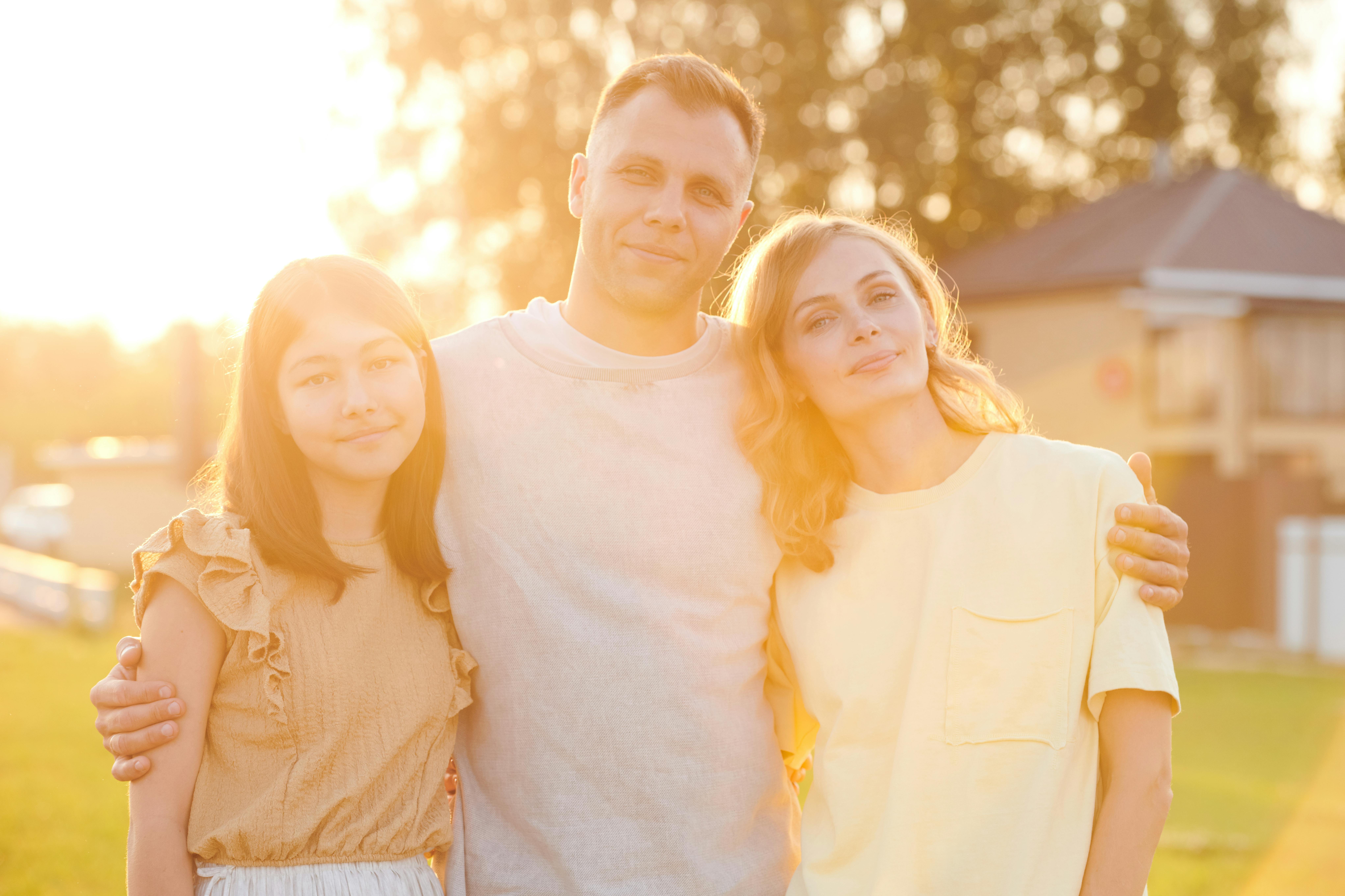 A man, a woman, and a young girl posing together | Source: Pexels