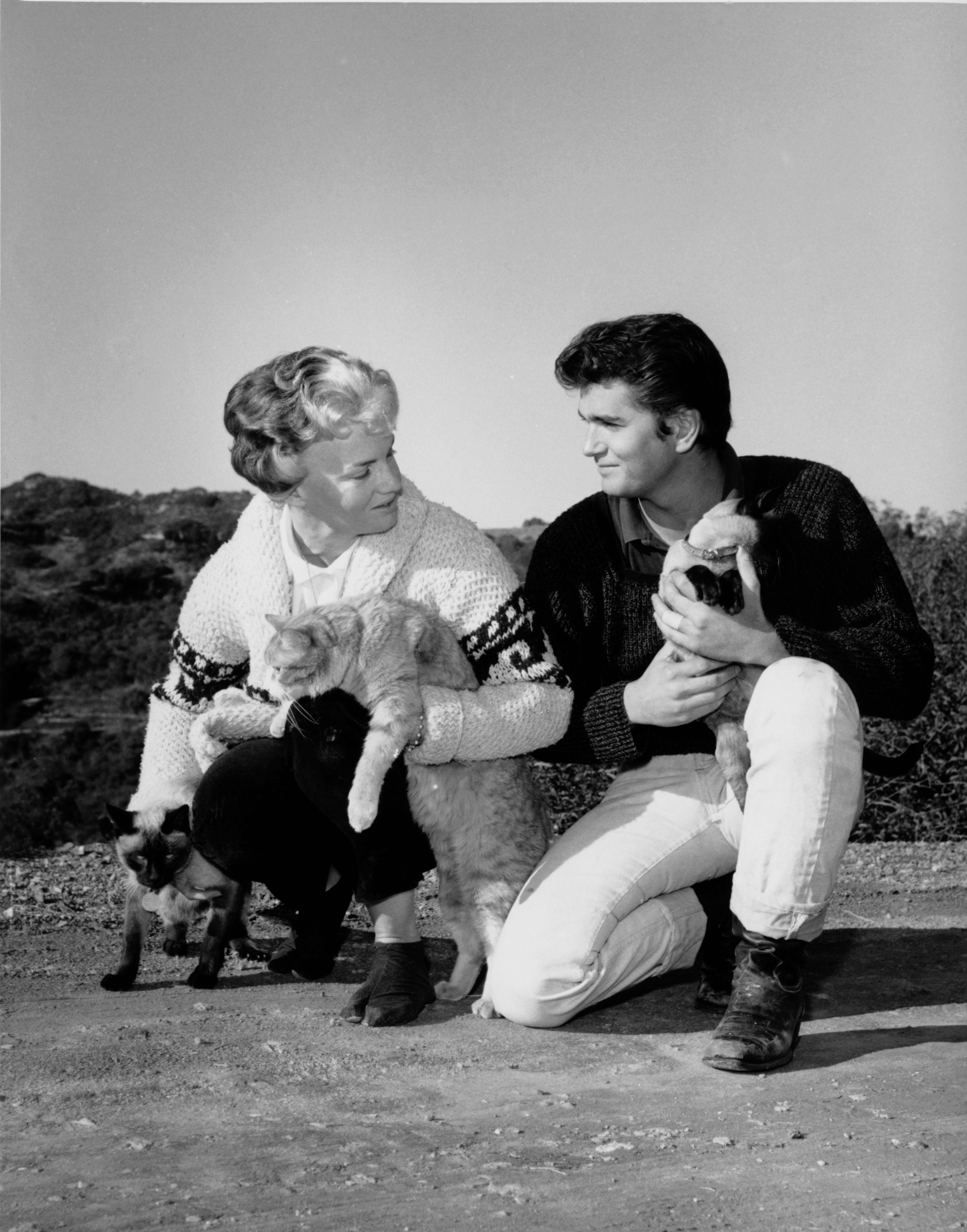 Dodie Levy-Fraser posing at home with Michael Landon and their cats, circa 1960. | Source: Archive Photos/Getty Images