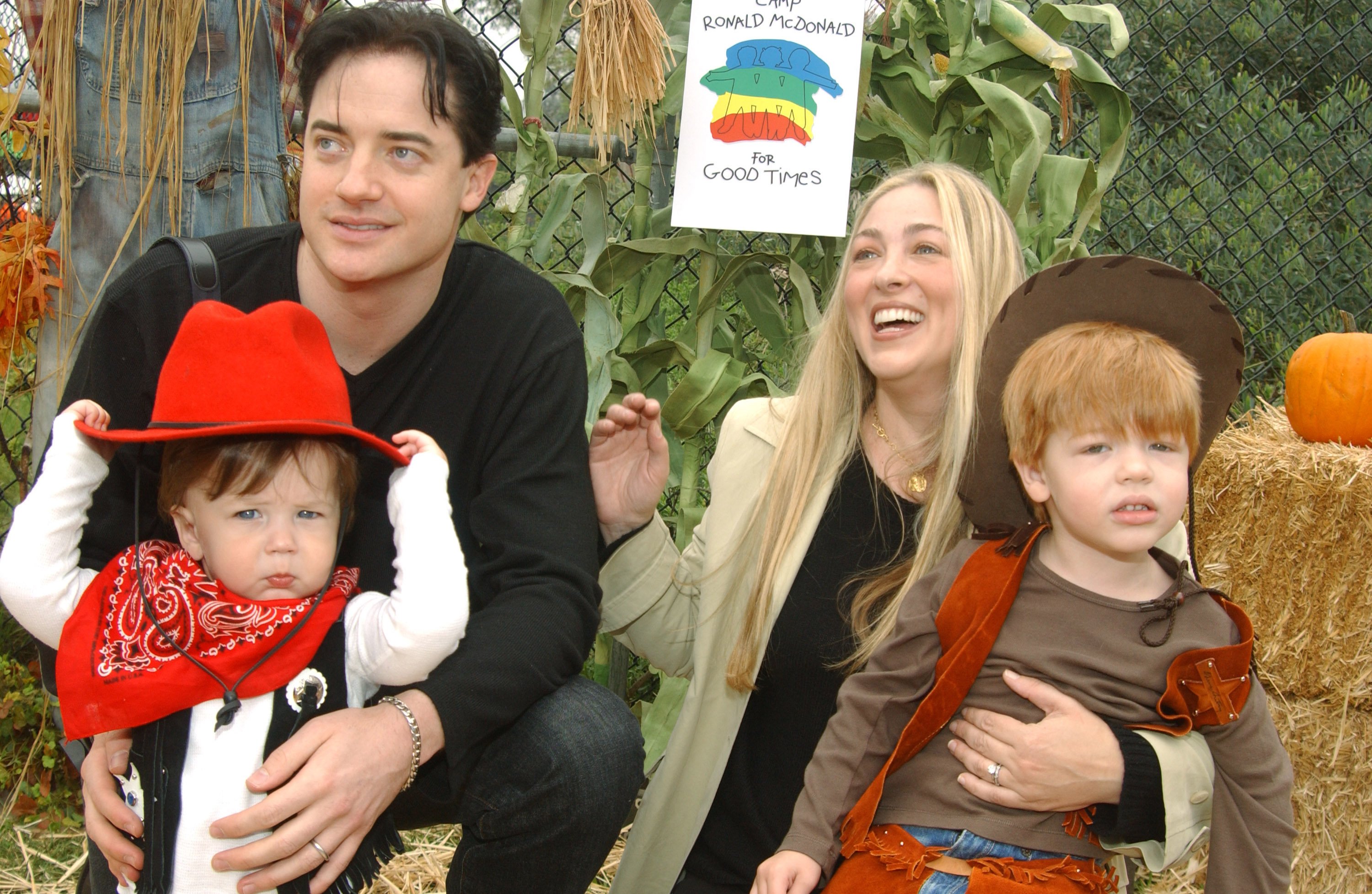 Brendan Fraser and Afton Smith holding their sons Holden and Griffin Fraser at Universal Studios in Universal City, California | Source: Getty Images