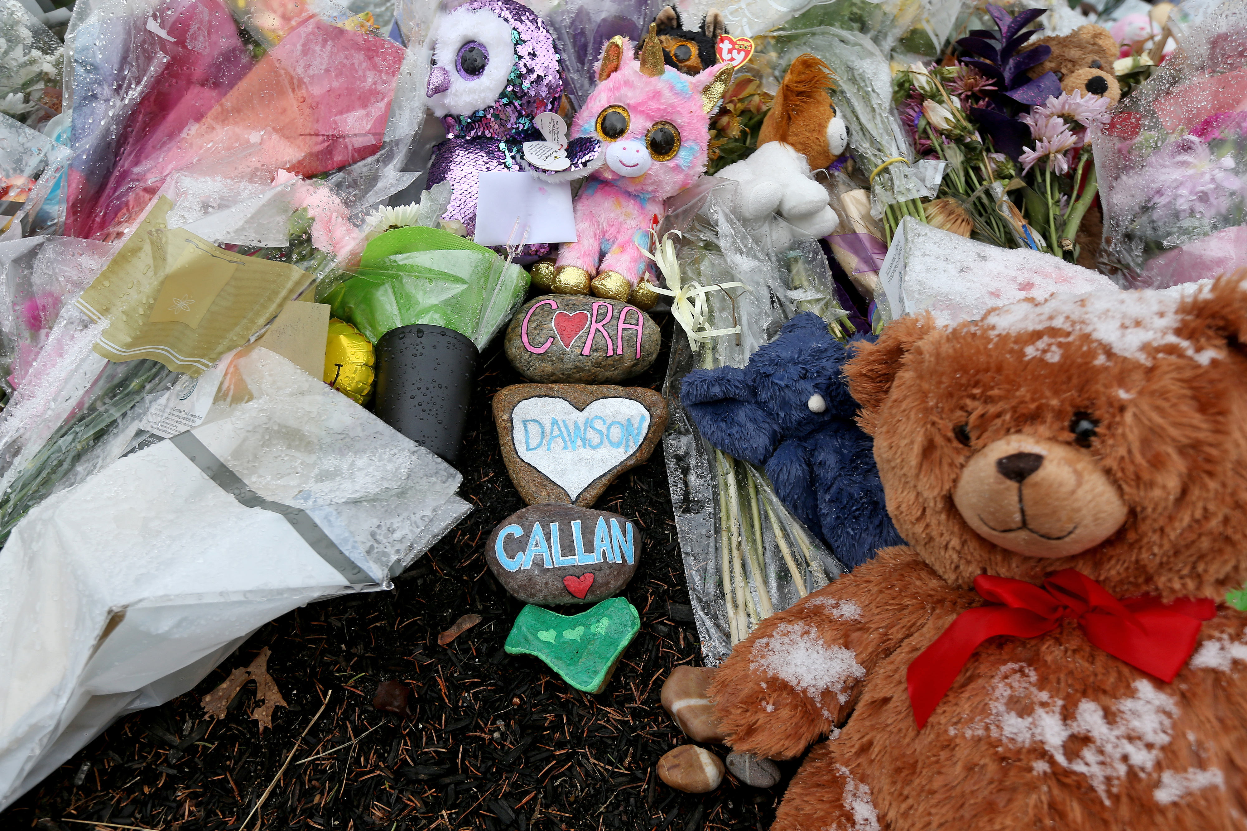 Flowers, stuffed animals, and memorial stones were left outside the Clancy family's Duxbury home in Duxbury, Massachusetts, on January 31, 2023, days after the deaths of Cora, Dawson, and Callan. | Source: Getty Images