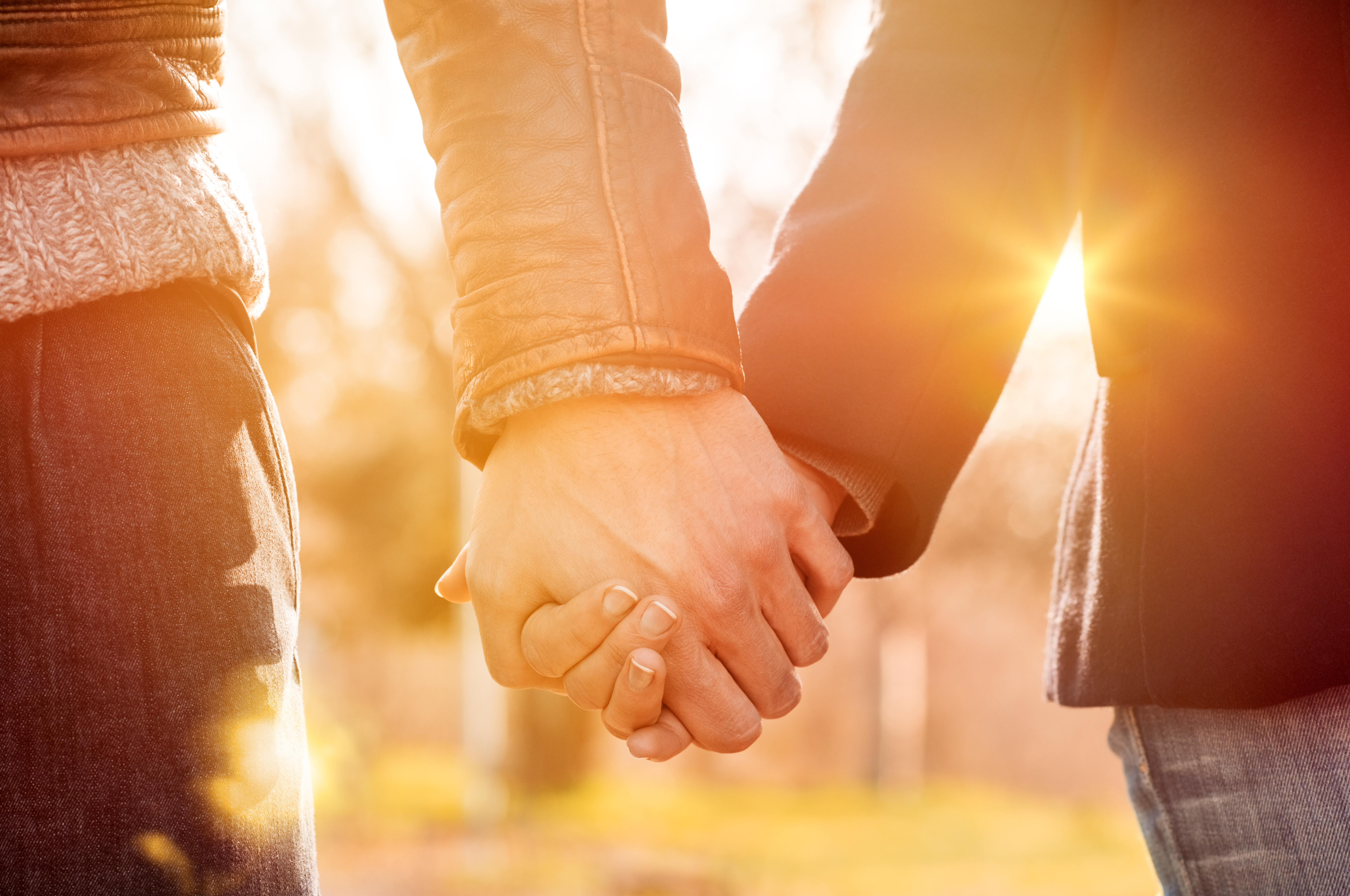 A couple holding hands | Source: Shutterstock
