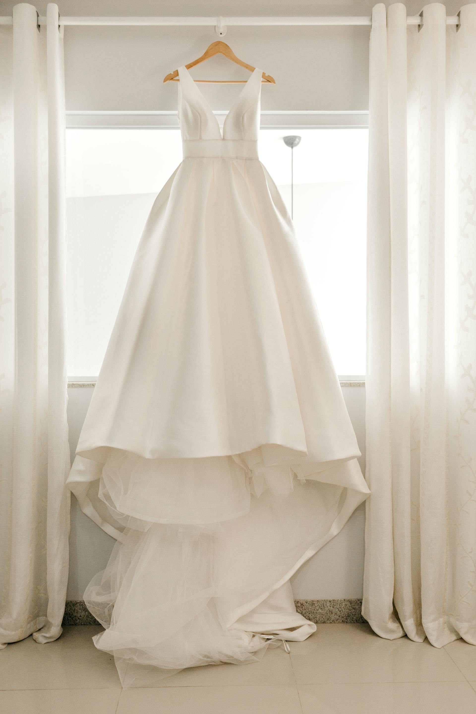 A white wedding dress on a hanger | Source: Pexels
