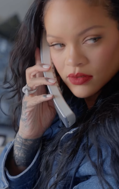 Rihanna listening to someone on the phone in her new video dated February 23, 2026 | Source: Instagram/badgalriri