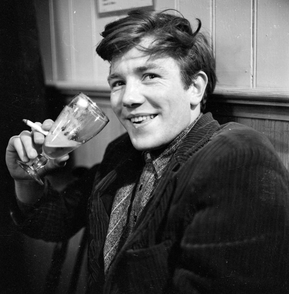 British film and stage actor Albert Finney enjoying a glass of beer in his regular pub behind the Cambridge Theatre in London | Getty Images