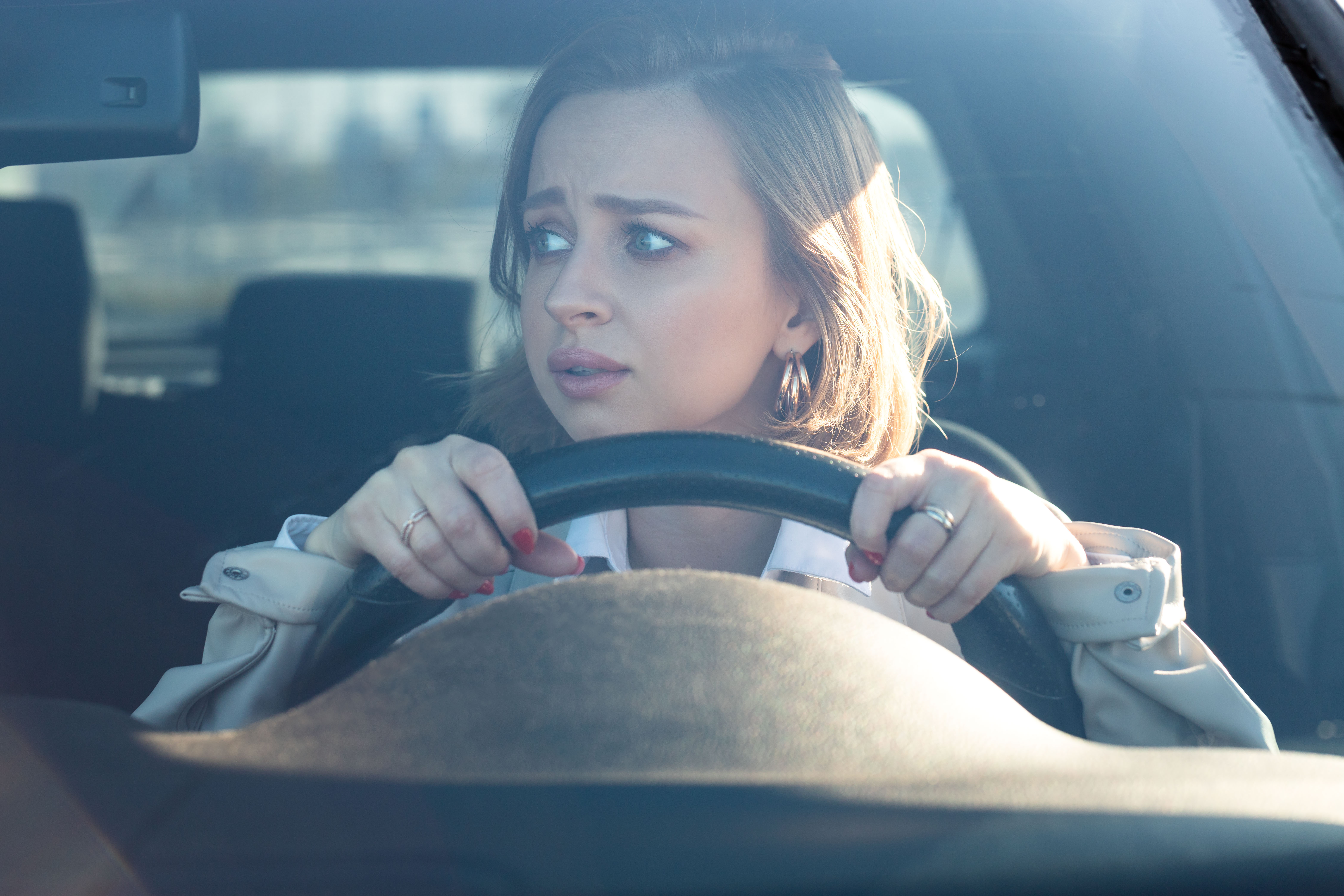 Woman drives her car for the first time, tries to avoid a car accident | Source: Shutterstock.com
