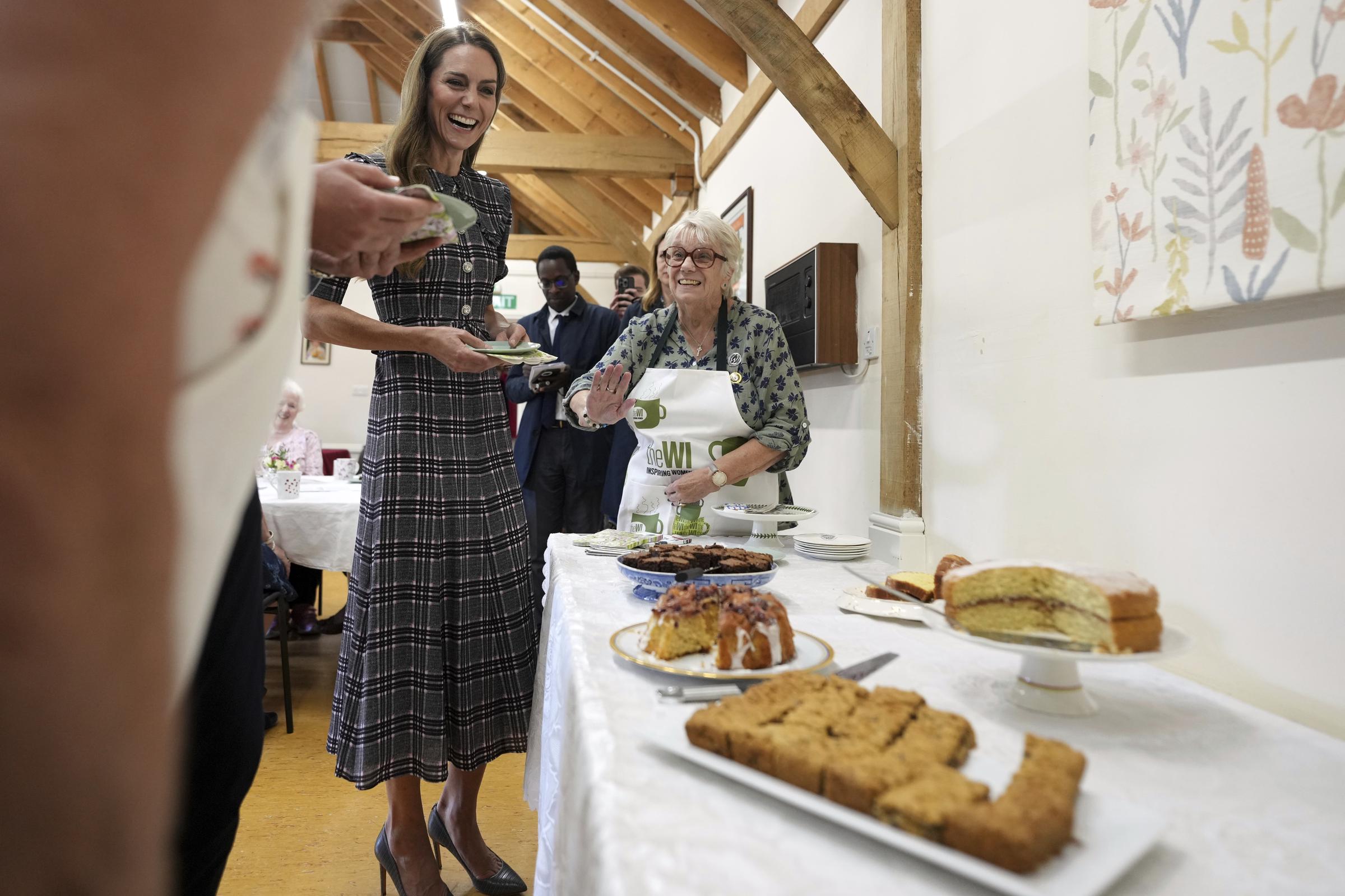 Princess Catherine laughing as she looks at all the delicious treats on display. | Source: Getty Images