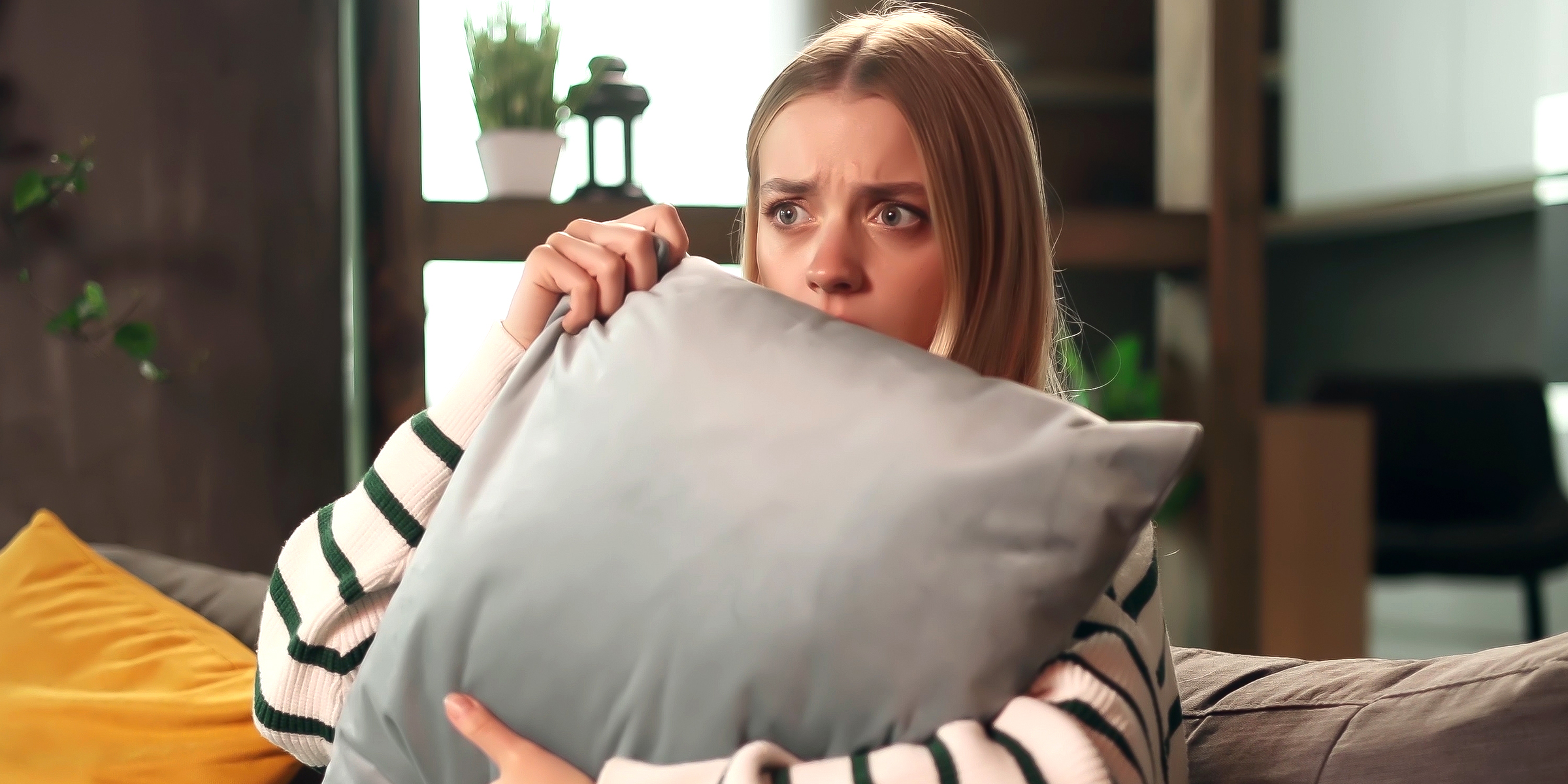 A woman holding a pillow | Source: Shutterstock