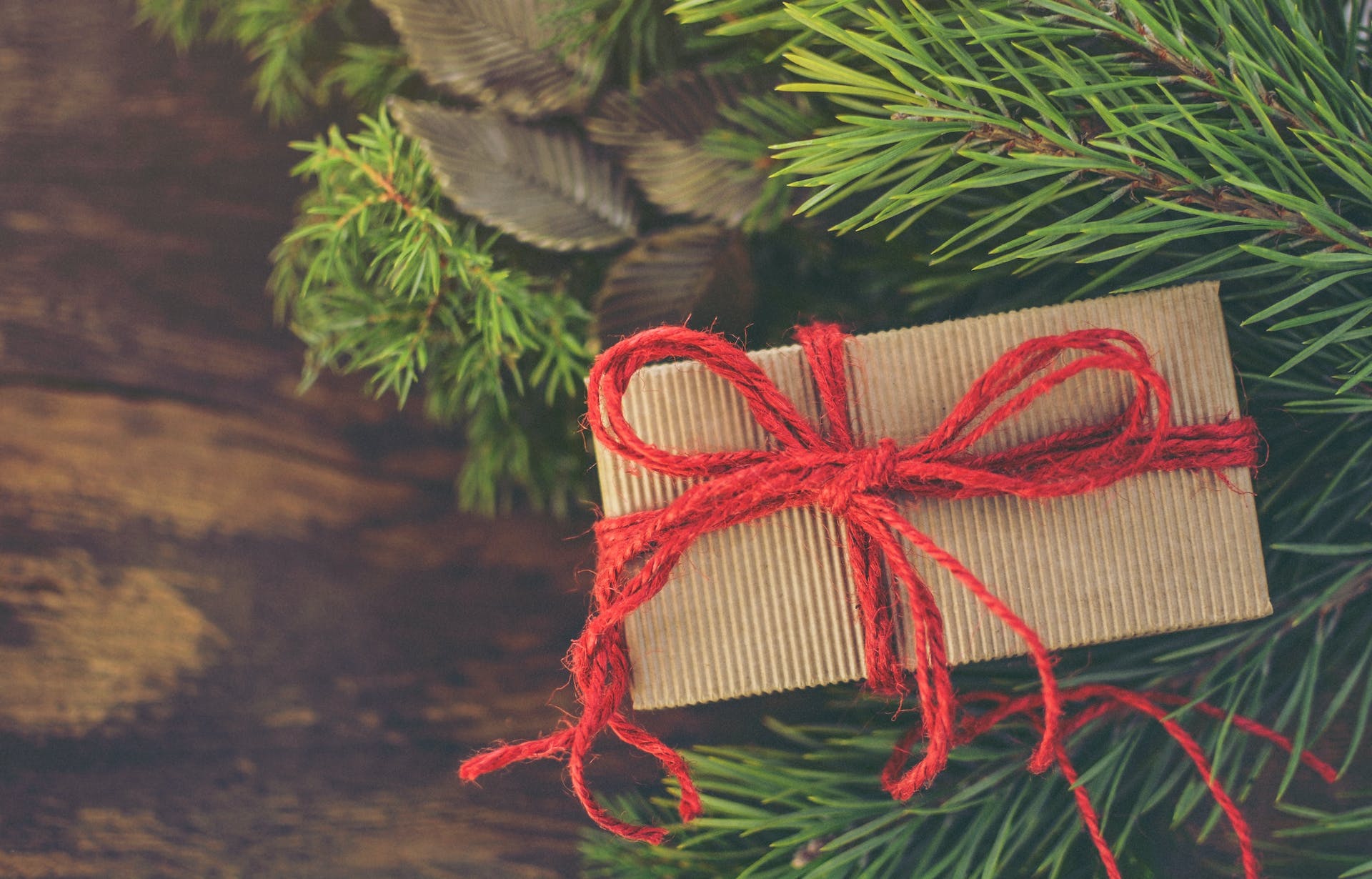 Christmas present wrapped with red thread | Source: Pexels