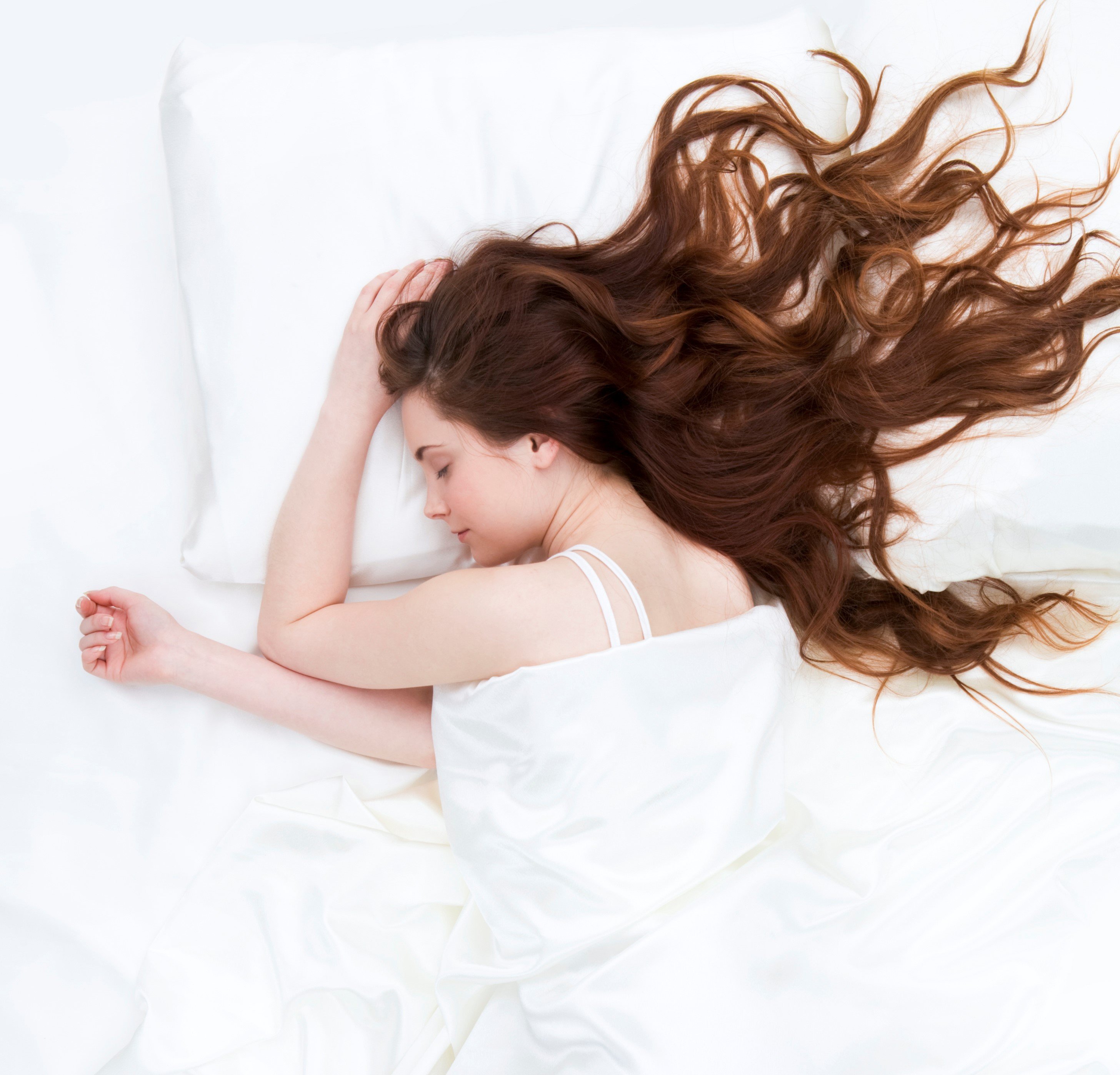 Woman sleeping on a satin sheets. | Source: Getty Images