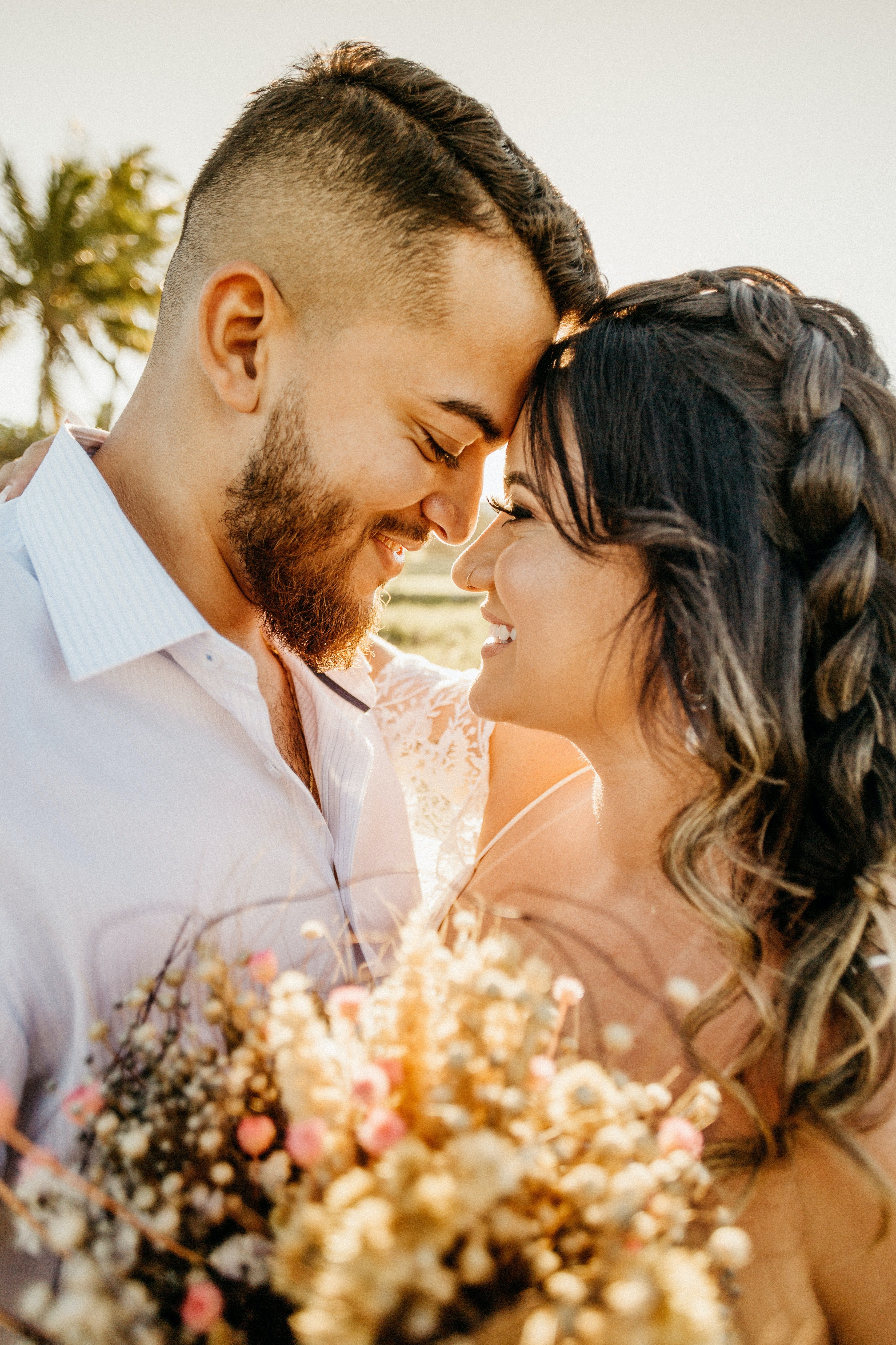 Pictured - A newly wedded couple glaring into each other's eyes while smiling and embracing each other on the beach on their wedding day. | Source: Pexels 