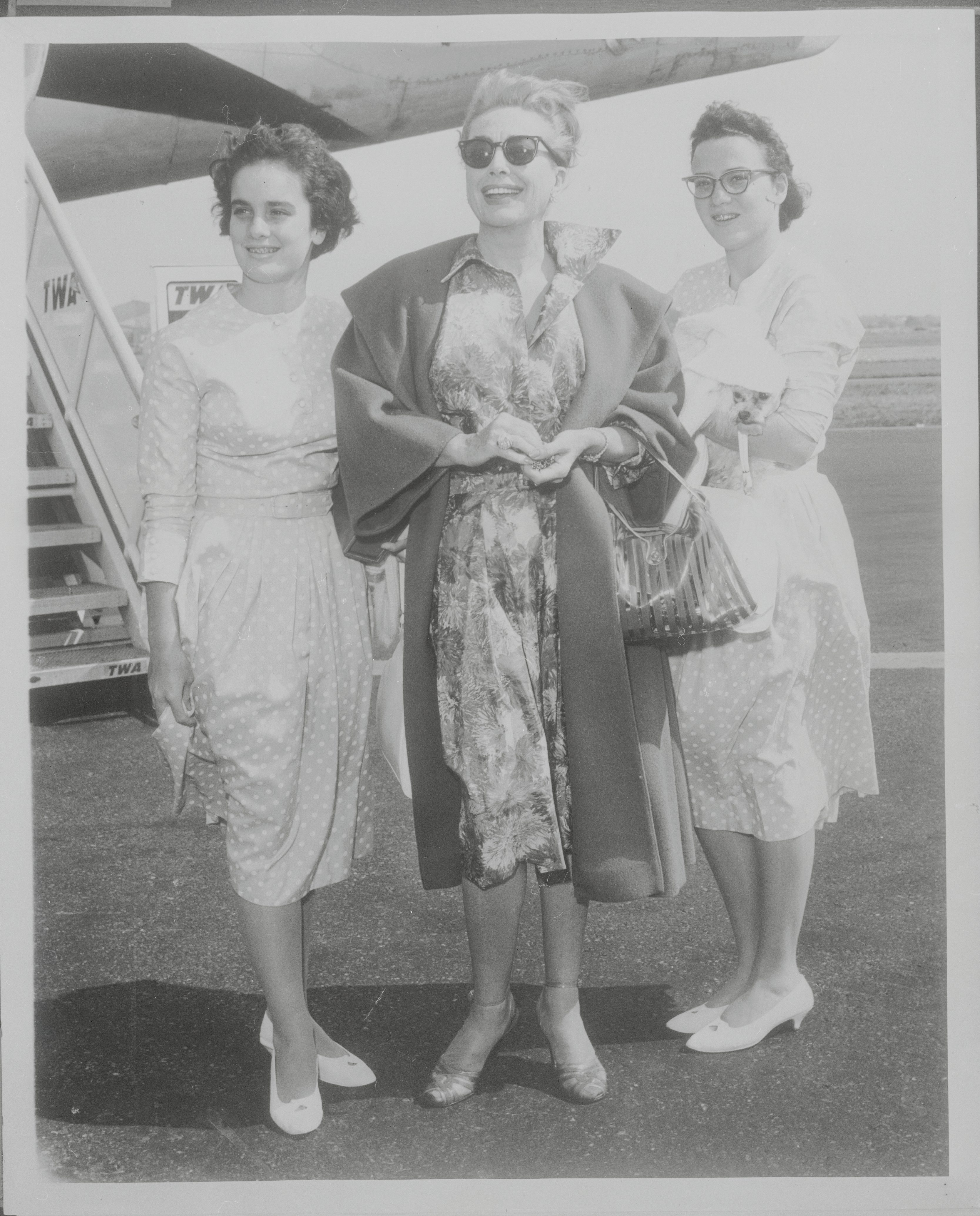 Joan Crawford pictured with her 13-year-old daughters Cathy and Cindy at Idlewild Airport. / Source: Getty Images