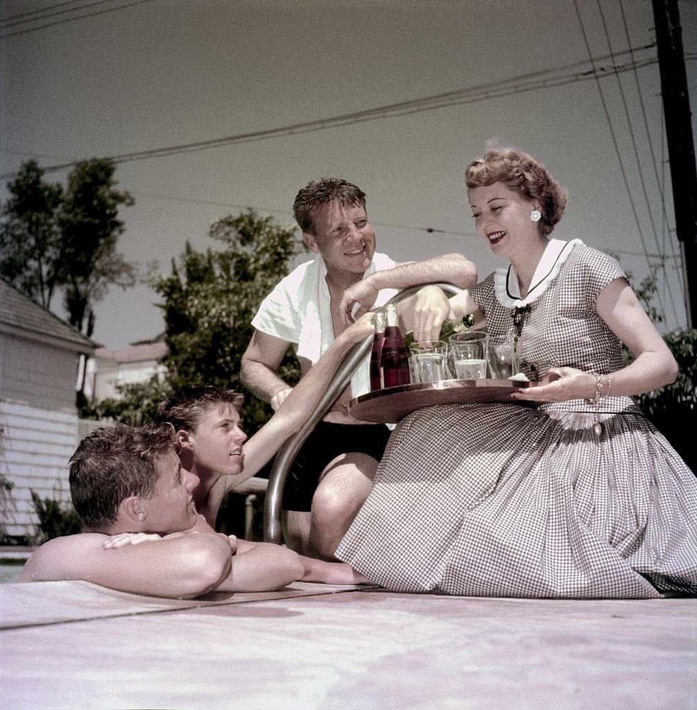 Actors and real life family The Nelsons: David Nelson, Ricky Nelson, Ozzie Nelson and Harriet Nelson [Left to Right] relax at their home pool in 1955 in Los Angeles, California. | Source: Getty Images