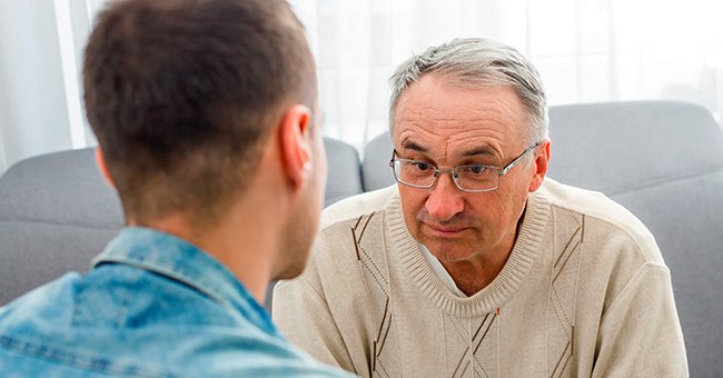 Man having a discussion with his son. | Photo: Shutterstock