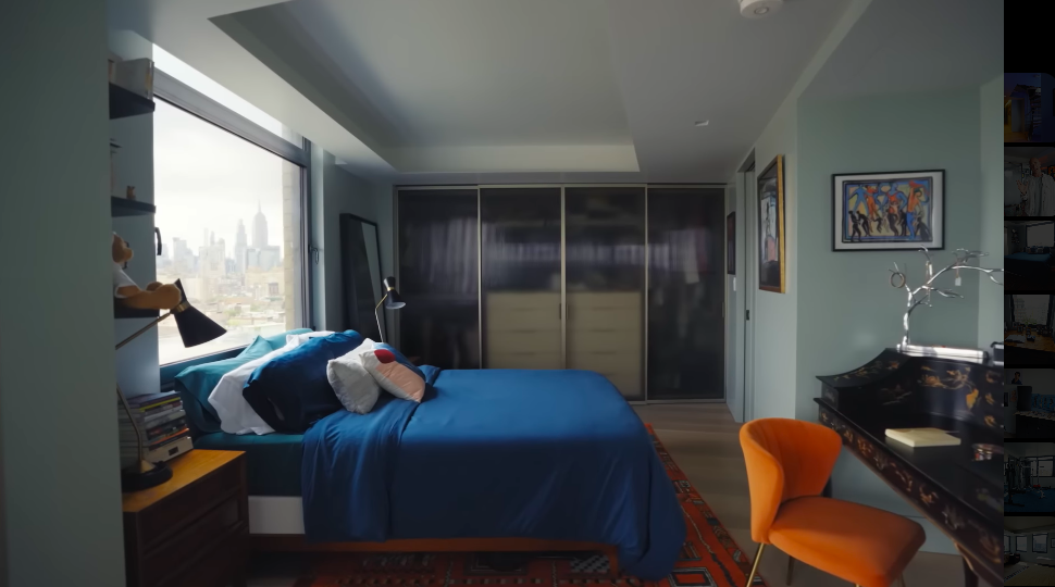 Christopher called this Sophia's "wing," and admitted the family made it enticing intentionally.With skyline views, rich blue bedding and its own sitting and working areas, leaving home would hardly be urgent. | Source: YouTube/Architectural Digest