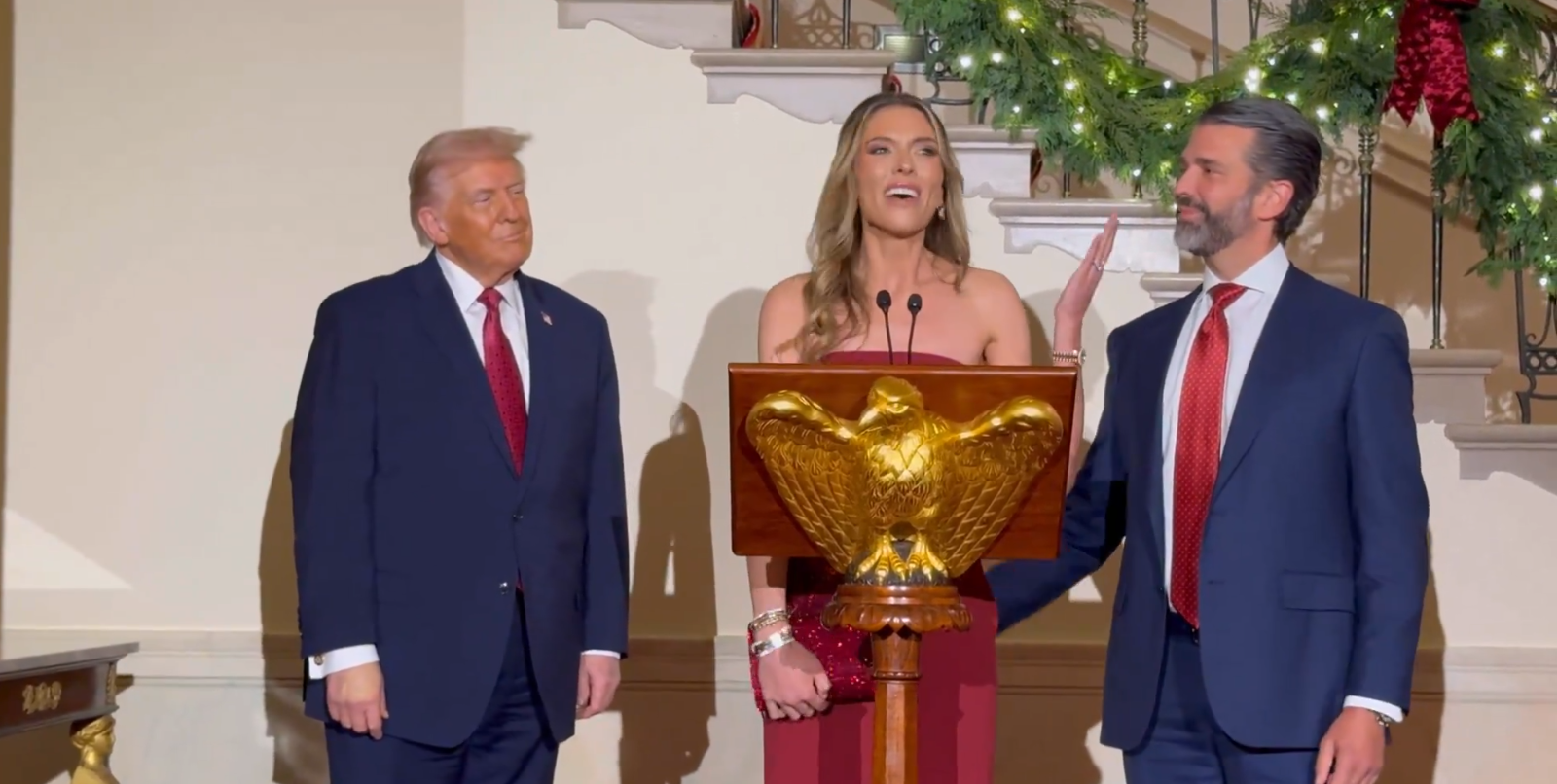 Donald Trump Jr. and his fiancée Bettina Anderson and President Donald Trump at the White House holiday event on December 15, 2025 | Source: X/LauraLoomer