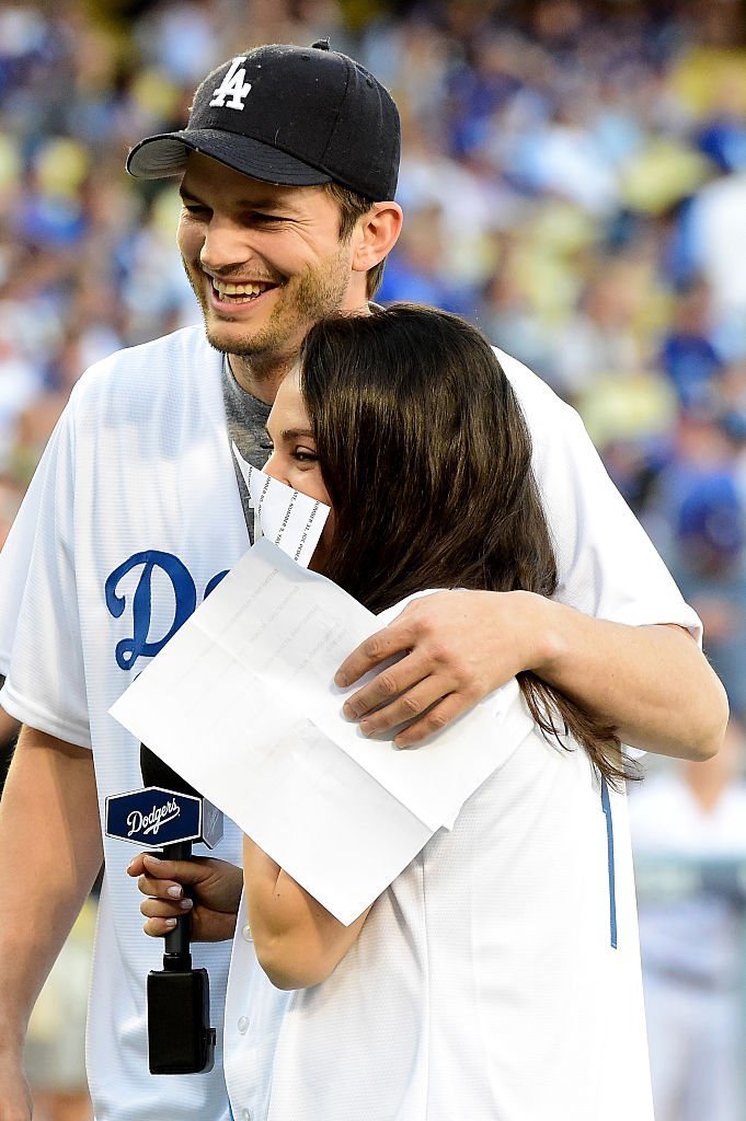 Ashton Kutcher and wife Mila Kunis annouce the Los Angeles Dodgers starting lineup before game four of the National League Championship Series | Getty Images