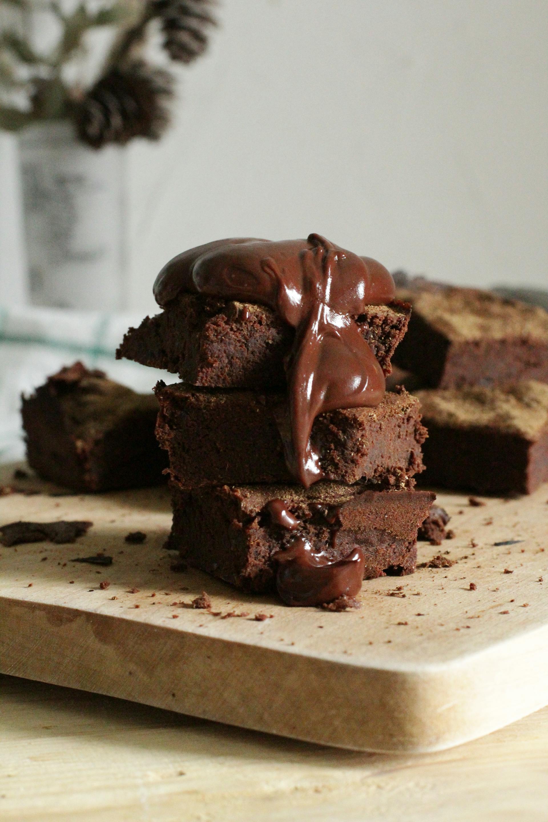 A closeup of stacked brownies on a chopping board | Source: Pexels