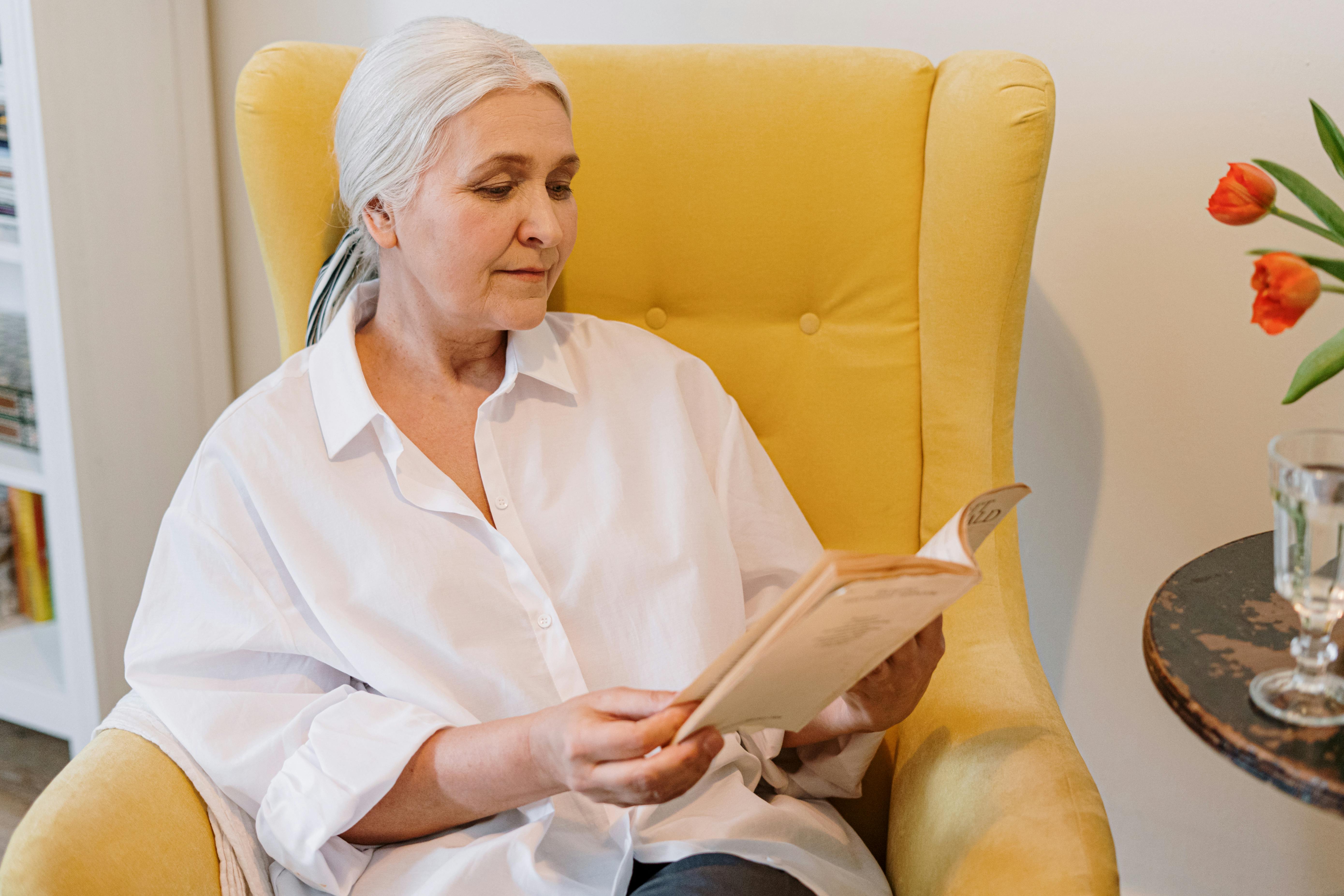 A grandmother reading in a chair | Source: Pexels