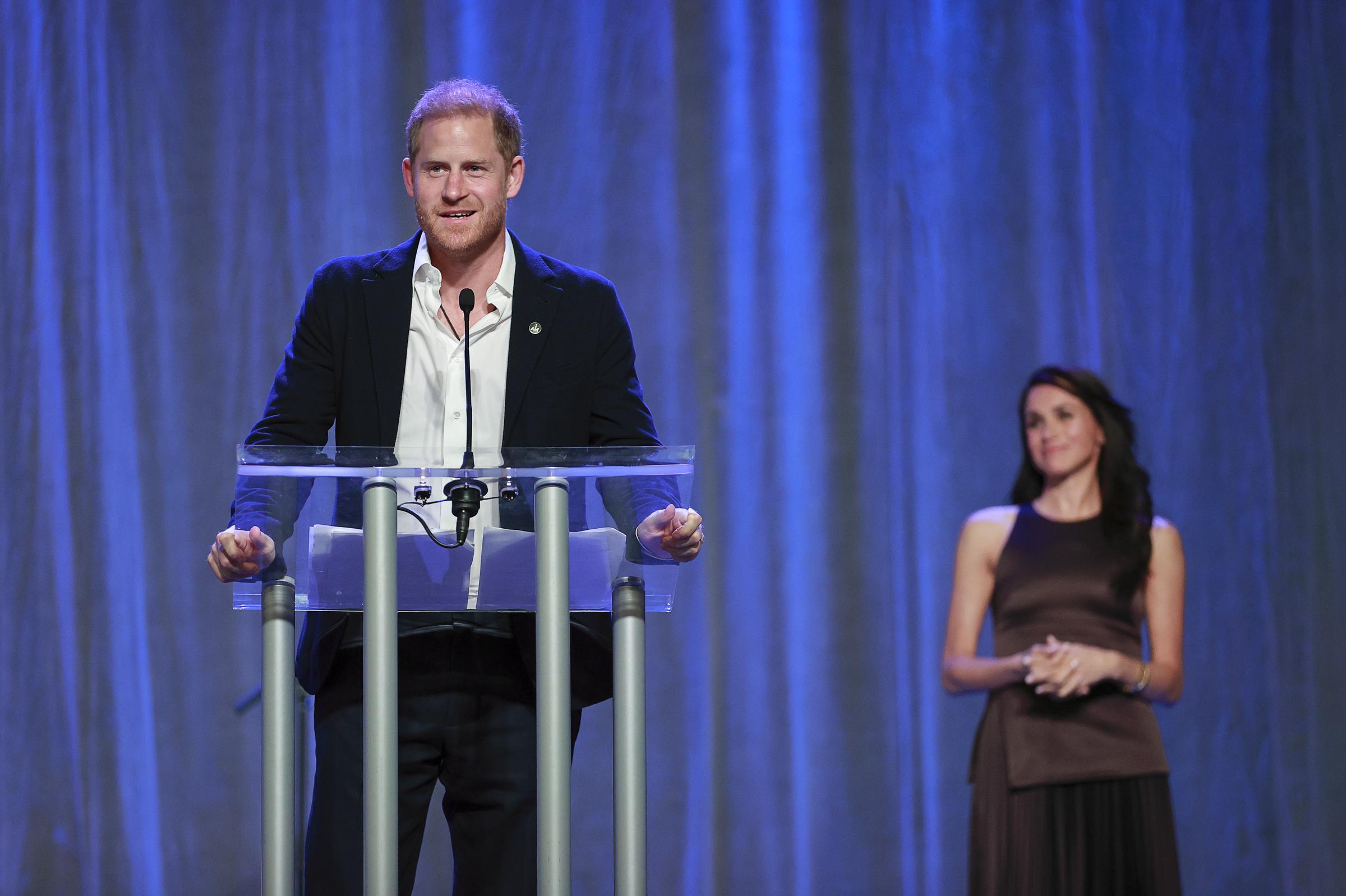 Prince Harry and Meghan Markle on stage while the Duke delivered remarks at the Invictus Games Vancouver Whistler 2025 Nation Home Welcome Reception on February 7, in Canada. | Source: Getty Images