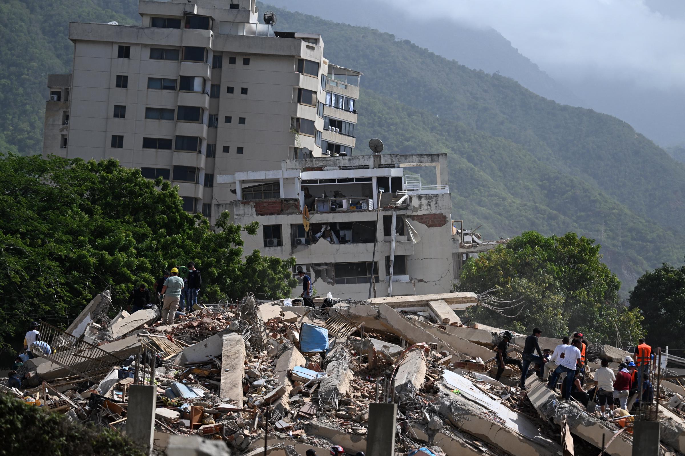 Apartment buildings across La Guaira suffered severe structural damage after the two powerful earthquakes struck just 39 seconds apart. For many families, including Lucas Trejo's, seeing homes reduced to ruins marked the beginning of an agonizing wait for answers. | Source: Getty Images