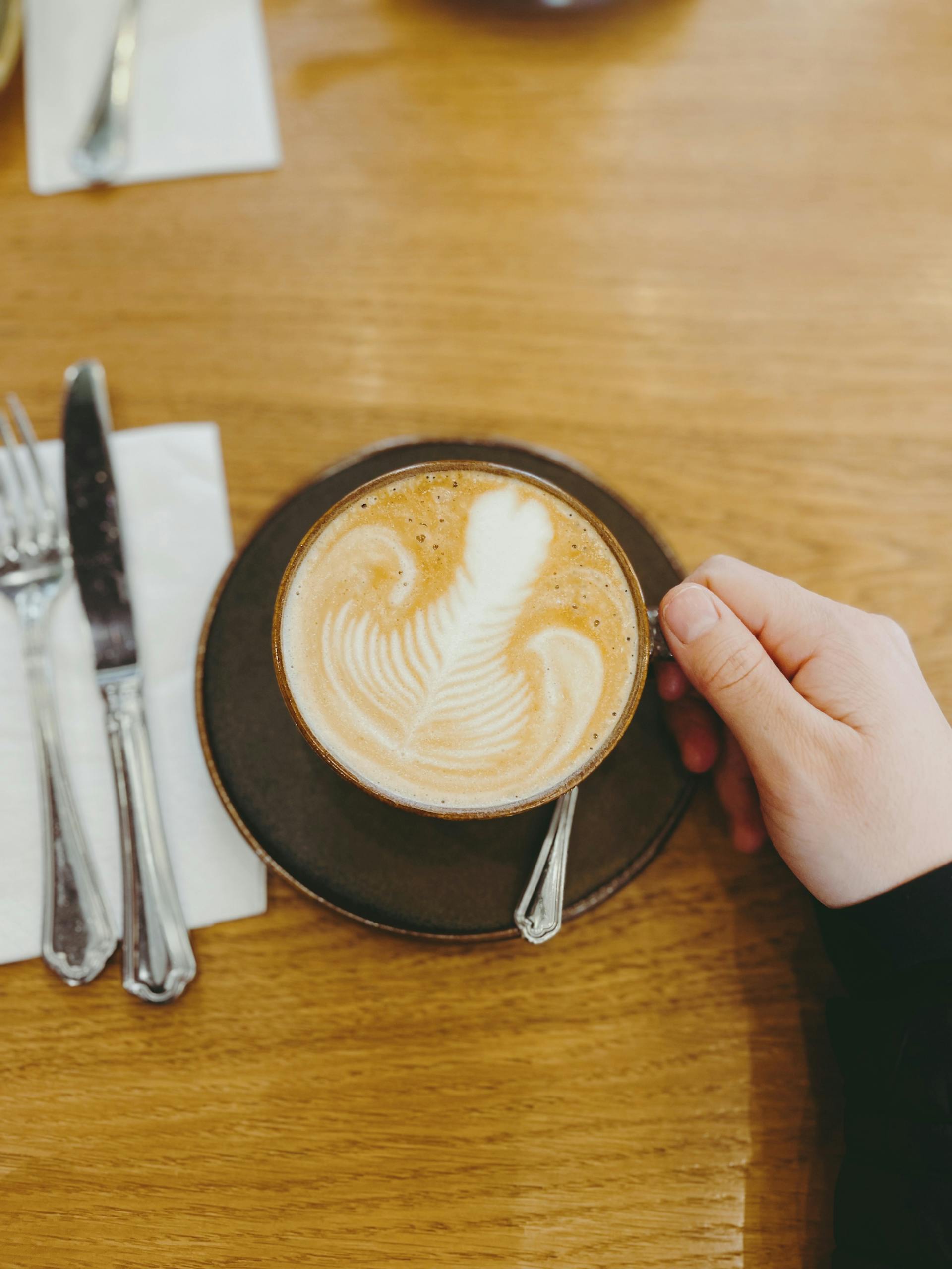 A woman holding her coffee | Source: Pexels