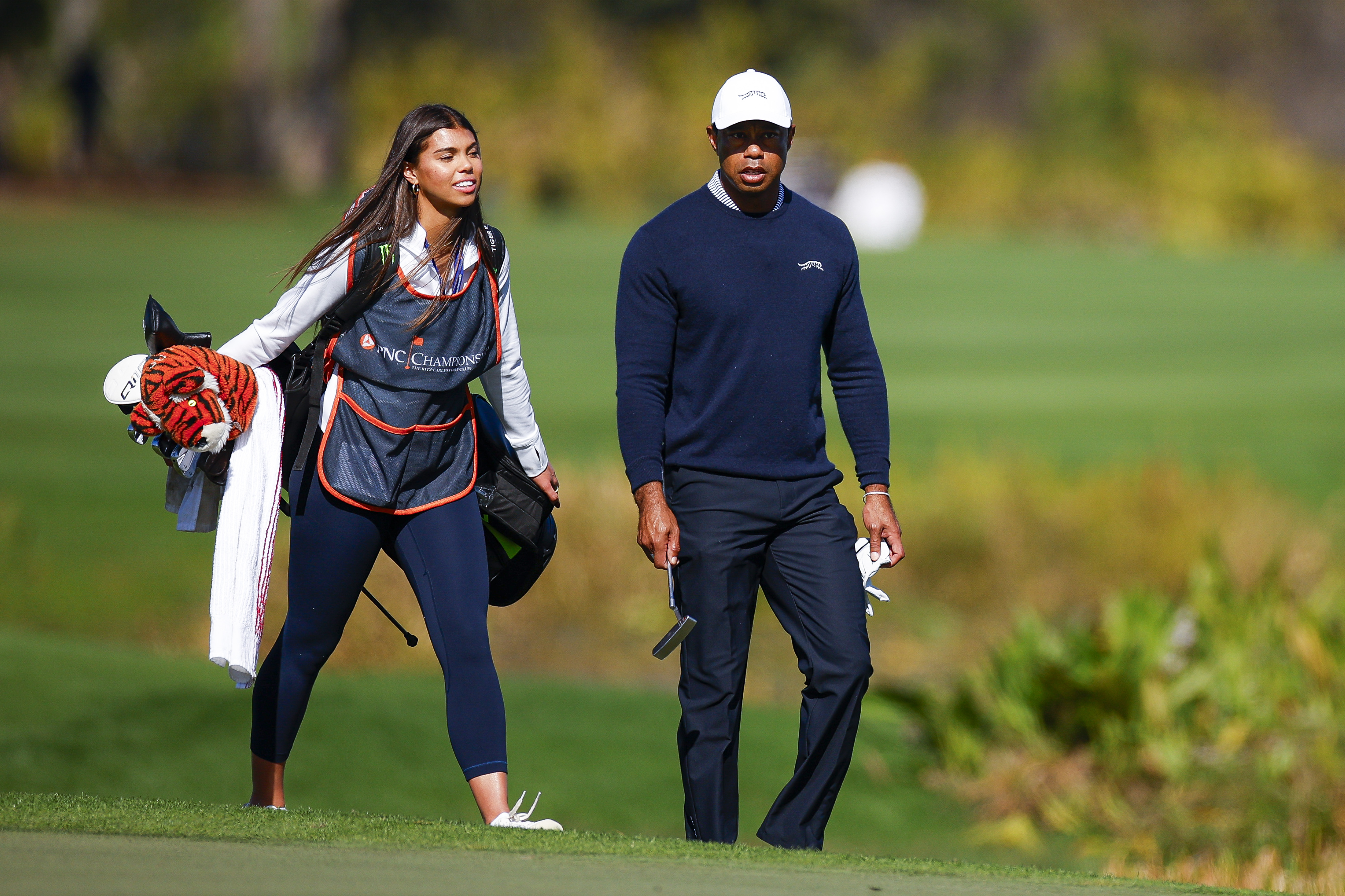 Sam and Tiger Woods walk the fifth hole during the first round of the PNC Championship | Source: Getty Images