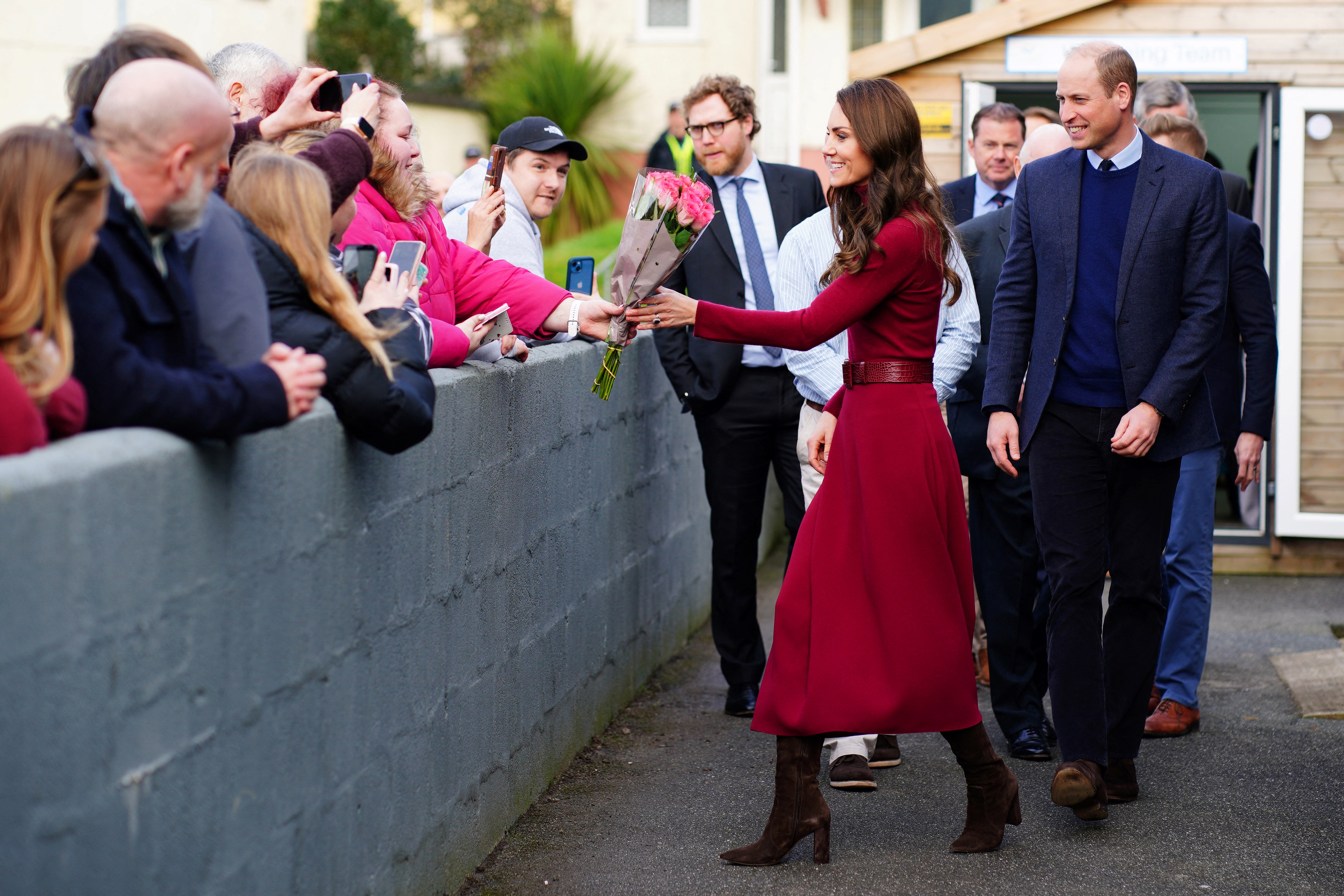 Princess Catherine receiving flowers from fans during her visit to the Dracaena Centre with Prince William in Cornwall, England on February 9, 2023 | Source: Getty Images