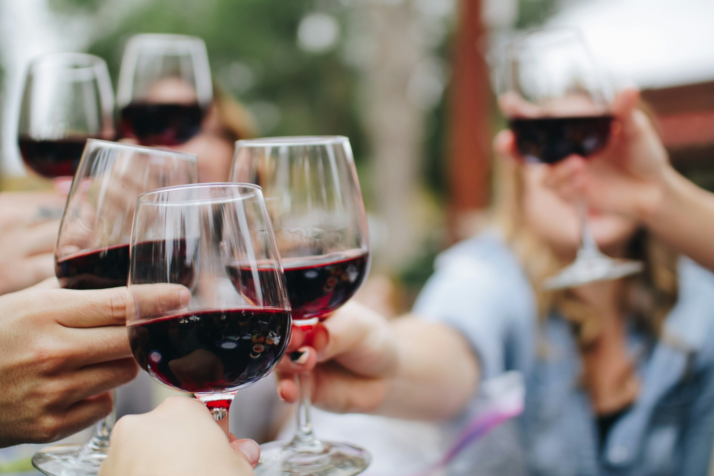 People holding glasses of wine | Source: Unsplash