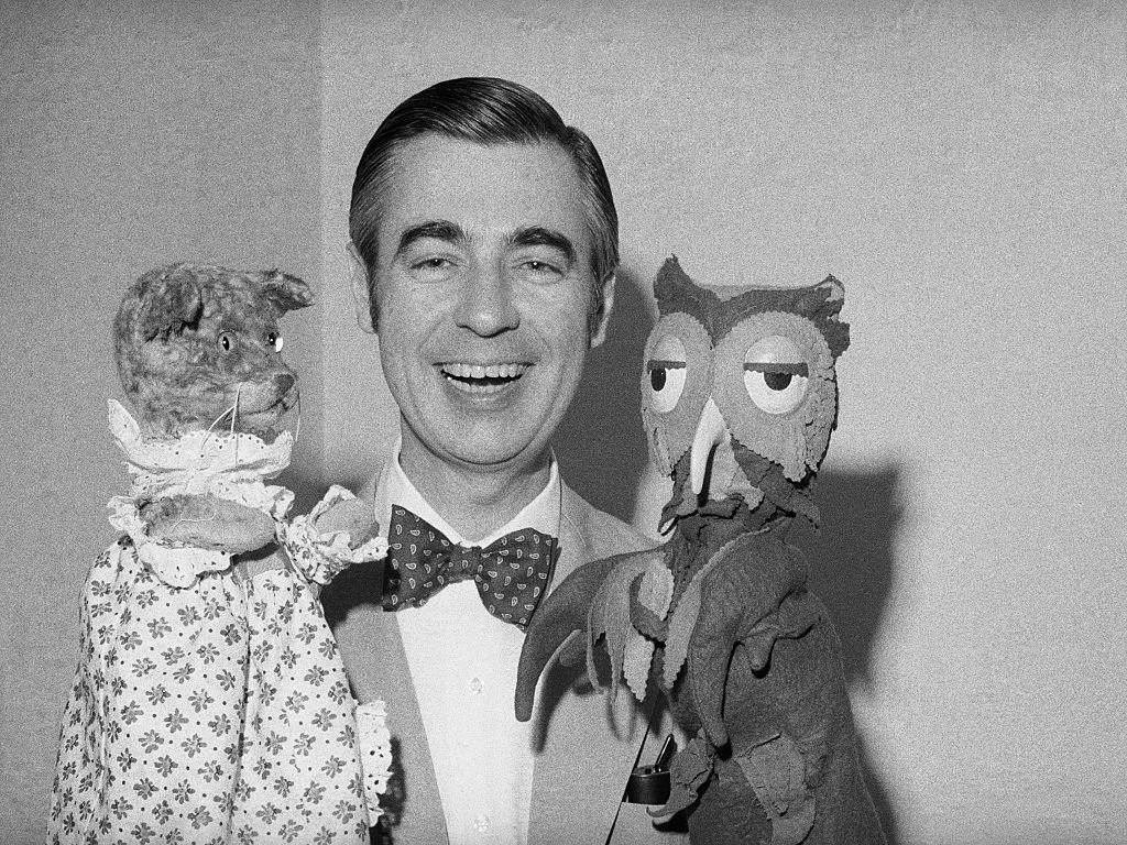 Fred Rogers of Mister Rogers' Neighborhood holds Henrietta Pussycat (left) and "X" the Owl during an interview.  | Getty Images