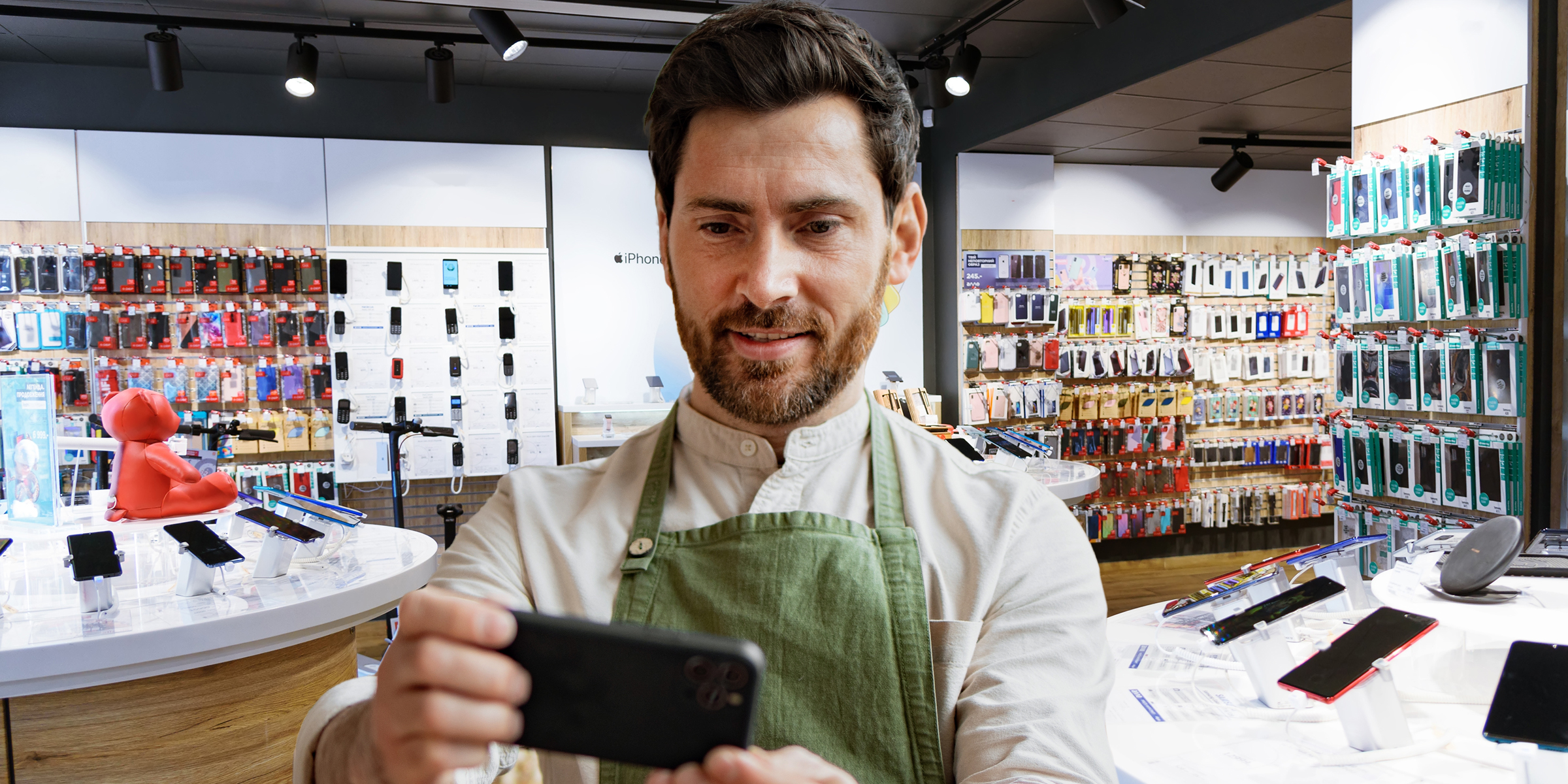 A man looking at a phone in a store | Source: Shutterstock