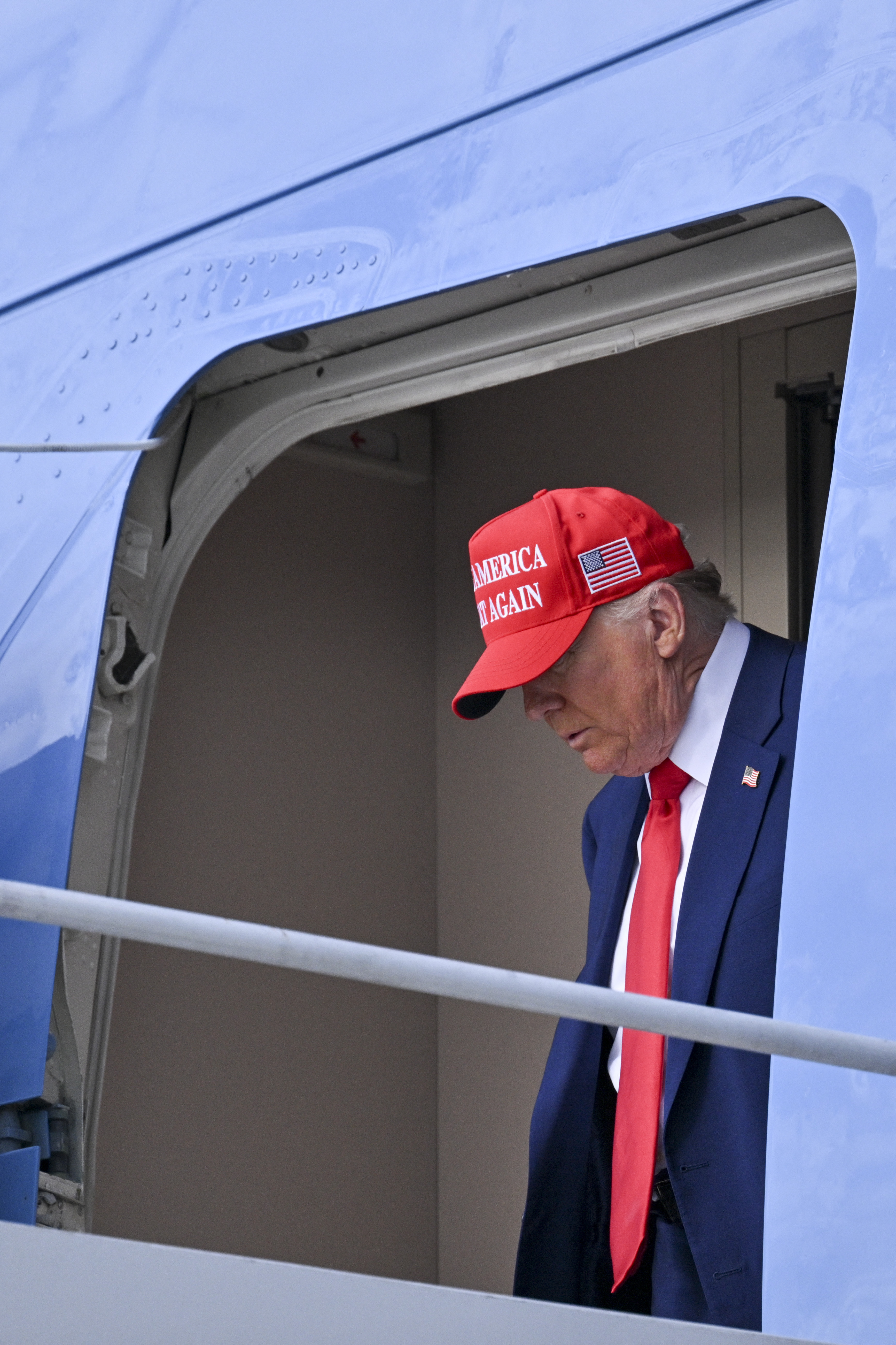 Donald Trump stepping off Air Force One after landing at the Palm Beach International Airport in West Palm Beach, Florida, on February 16, 2025, following his attendance at Daytona 500 earlier in the day. | Source: Getty Images