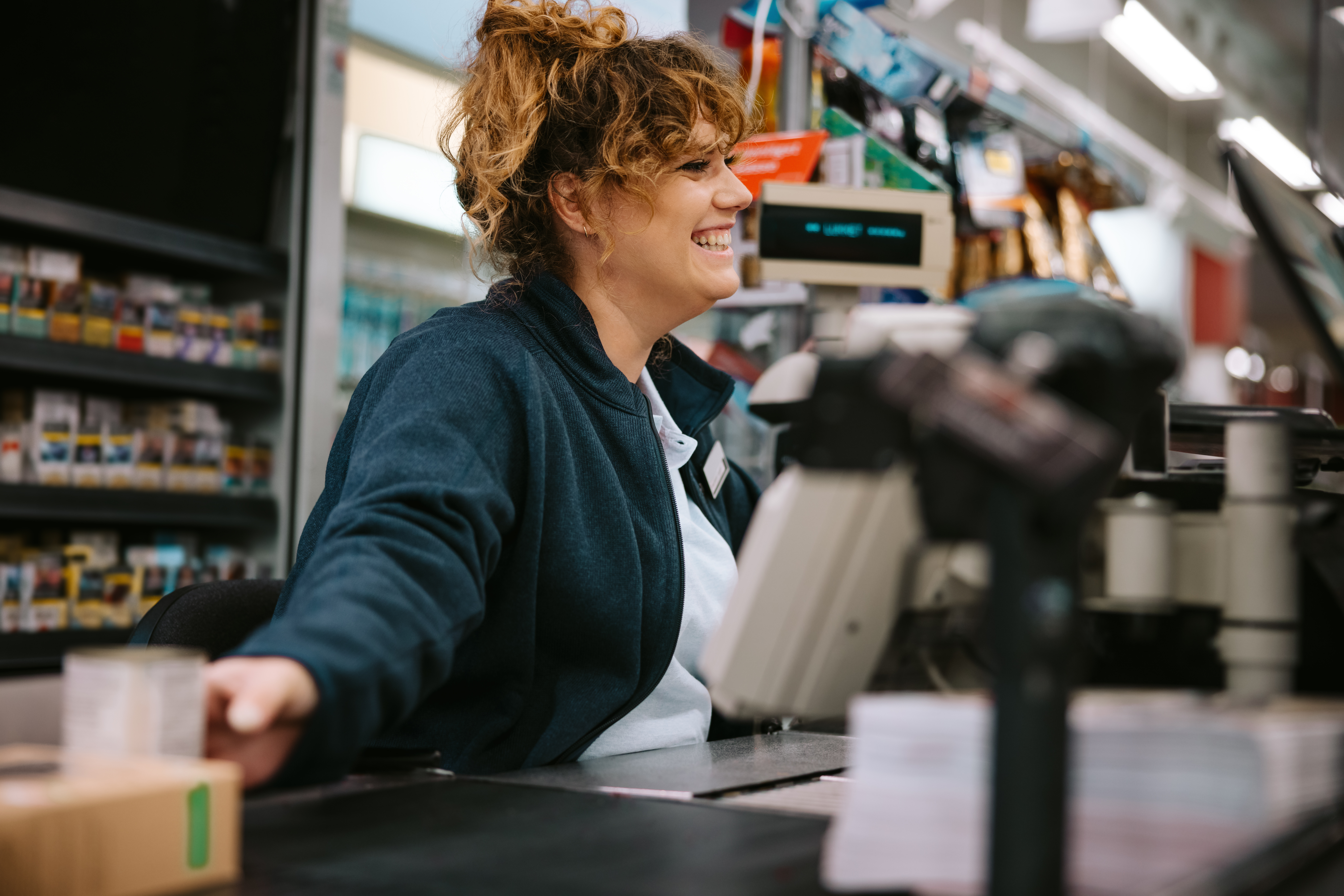 A woman working at a checkout counter | Source: Shutterstock