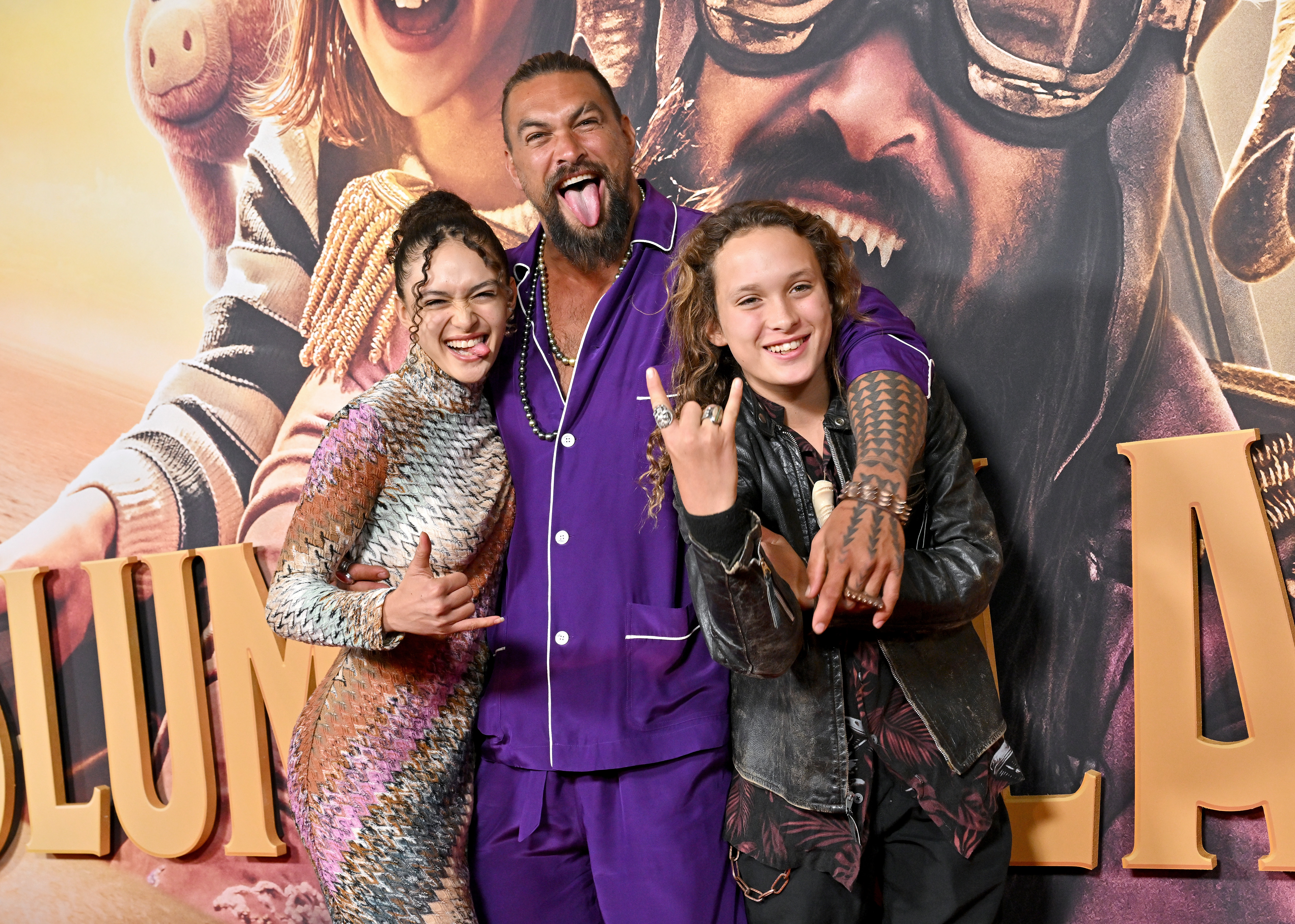 Grinning ear to ear and flashing a rock sign, Nakoa-Wolf and Lola Iolani Momoa joined their dad, Jason Momoa, at the "Slumberland" premiere, where their playful energy and bold style lit up the red carpet.