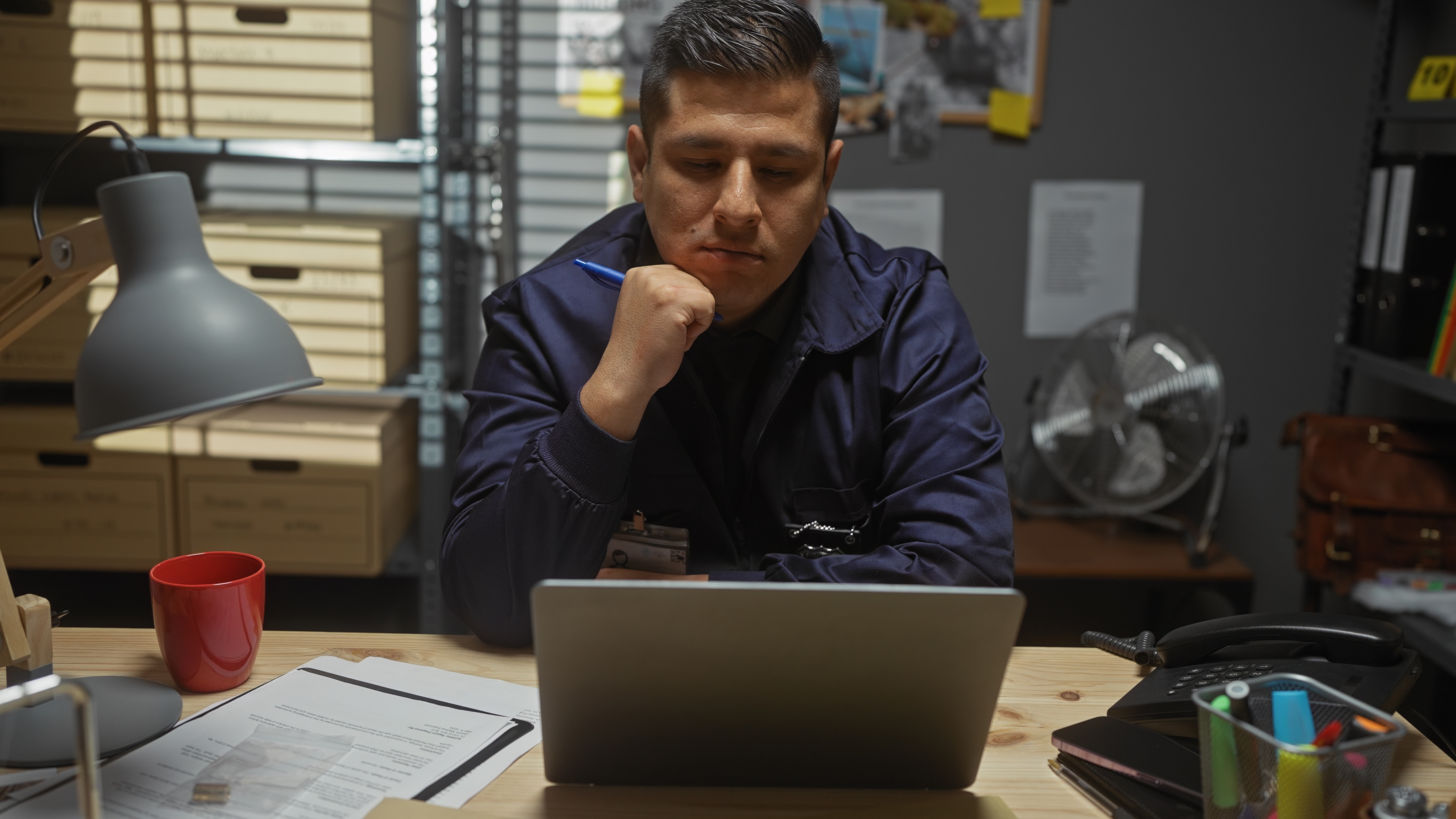 Man sitting at a desk using a laptop | Source: Shutterstock