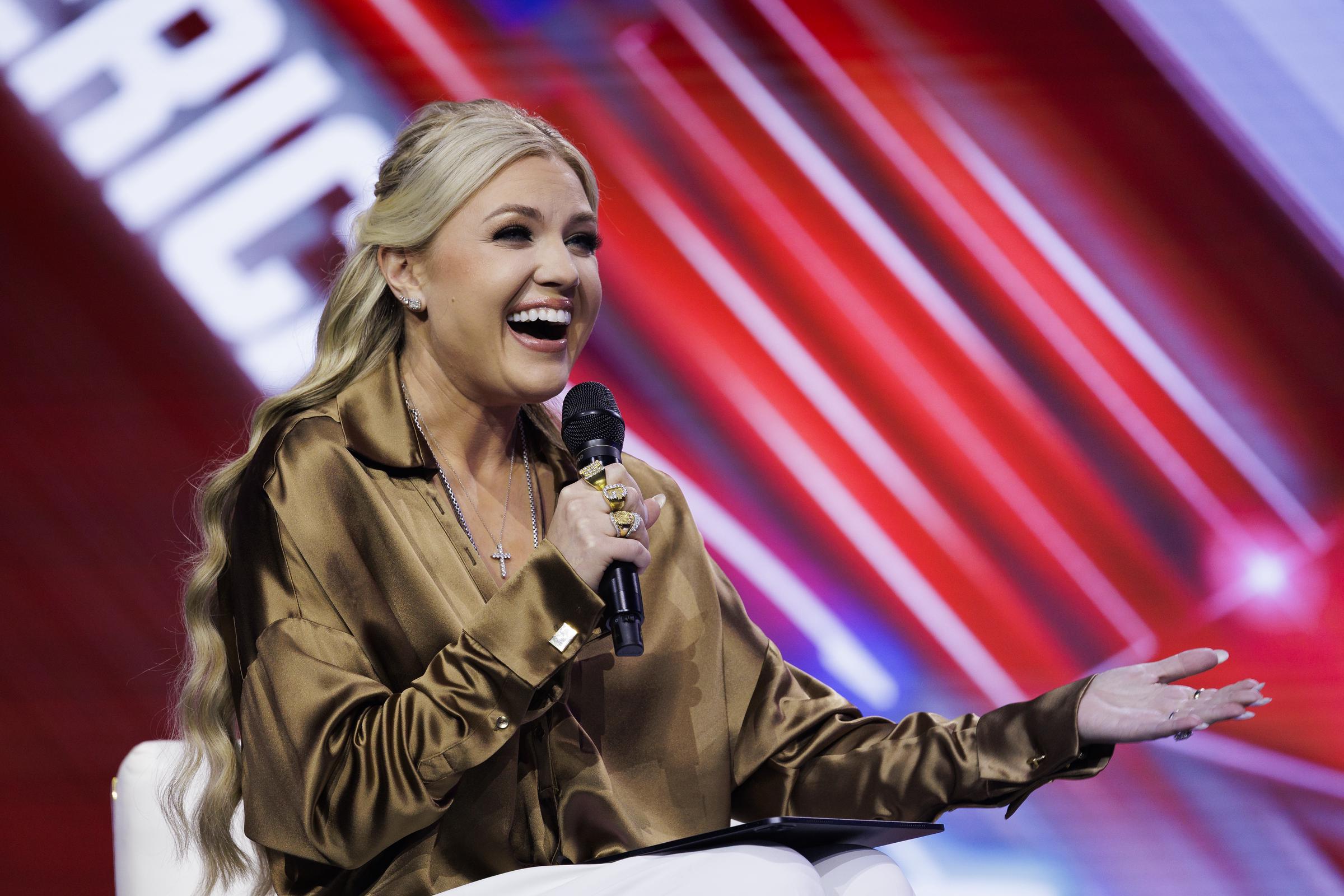 Erika Kirk reacts with a smile while speaking to Nicki Minaj during their onstage conversation at AmericaFest on December 21, 2025 | Source: Getty Images