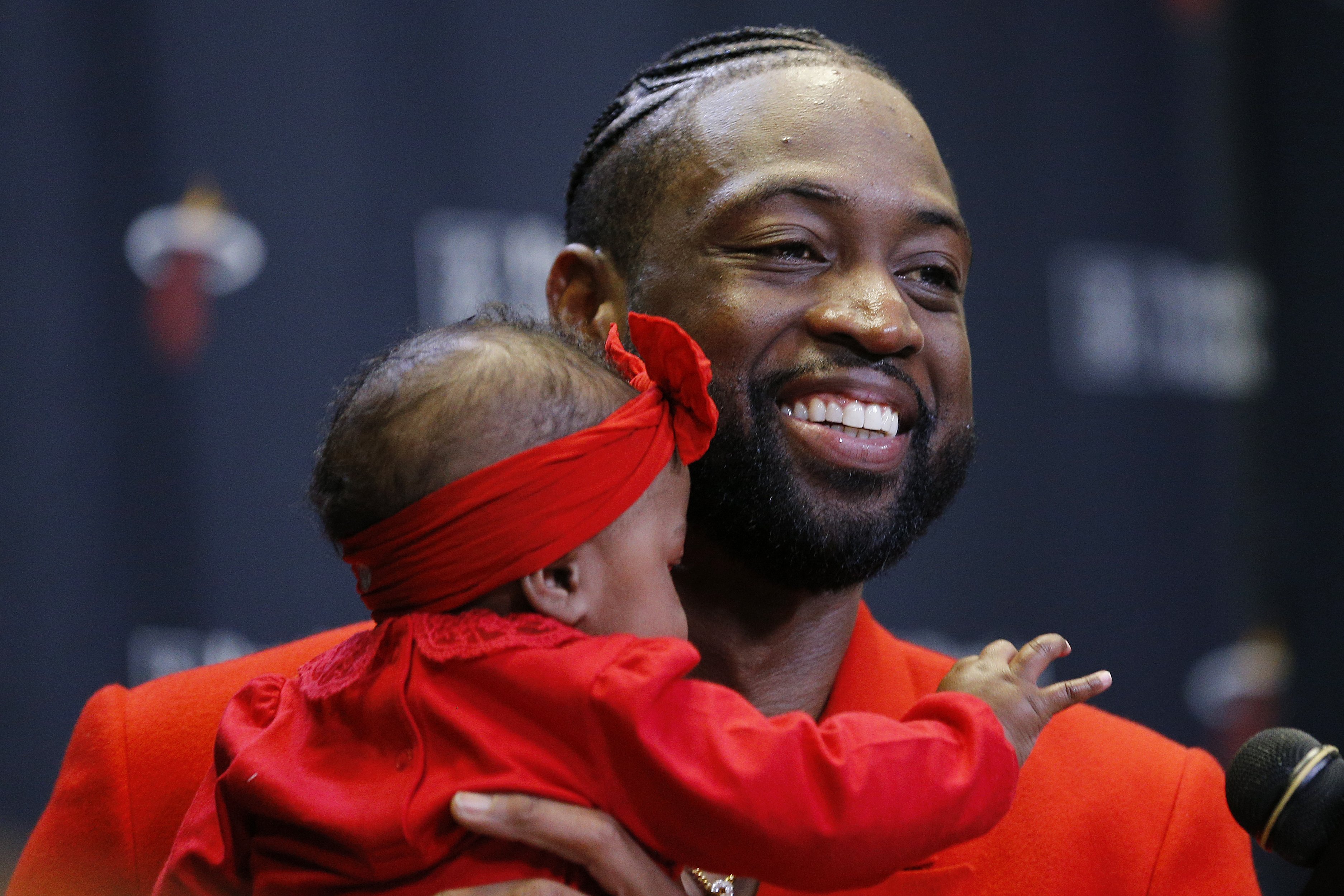 : Dwyane Wade #3 of the Miami Heat addresses the media after his final regular season home game at American Airlines Arena with his daughter, Kaavia James Union Wade, on April 09, 2019 in Miami, Florida. | Getty Images : pgotos