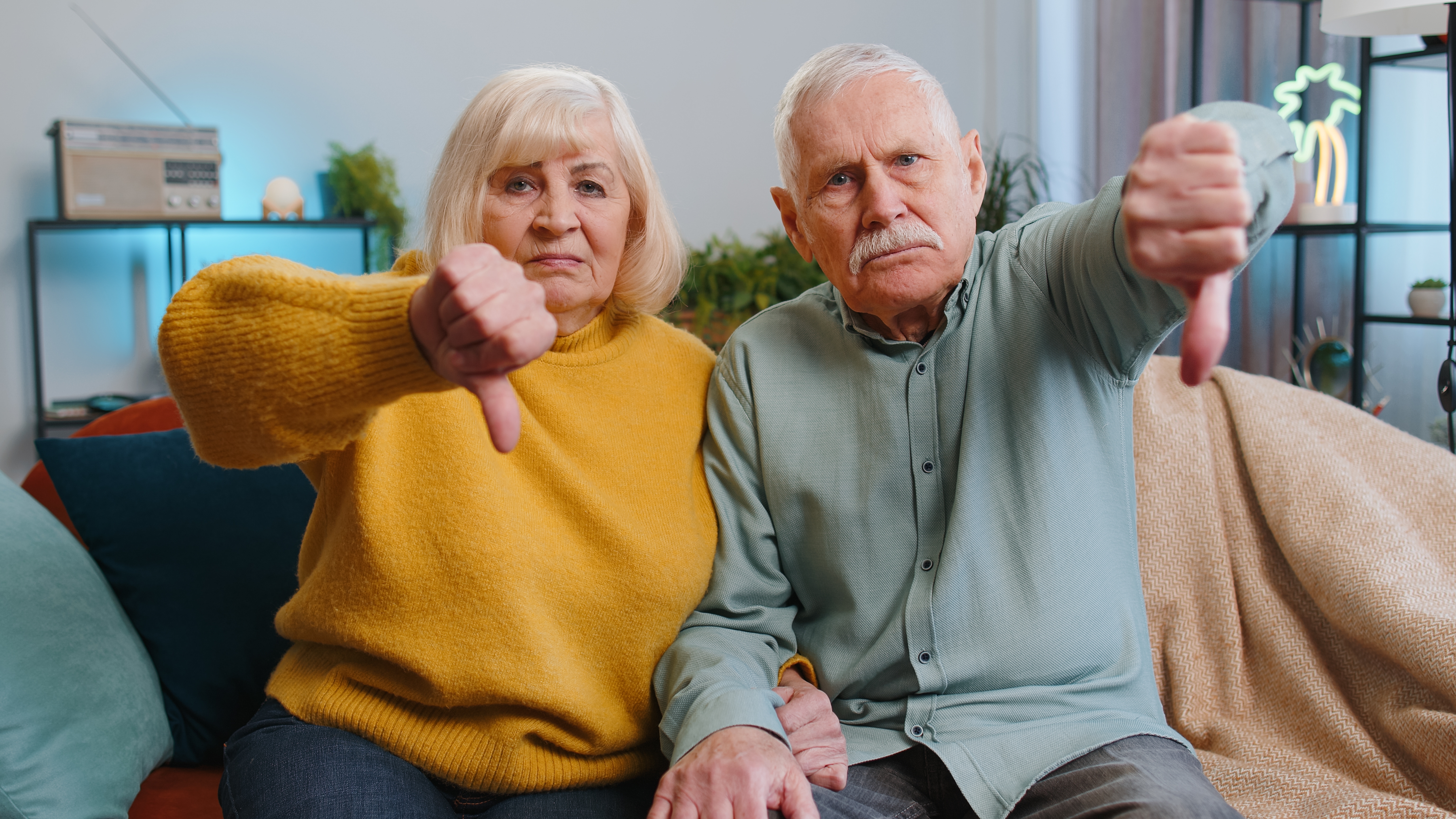 Senior couple showing thumbs down sign | Source: Shutterstock