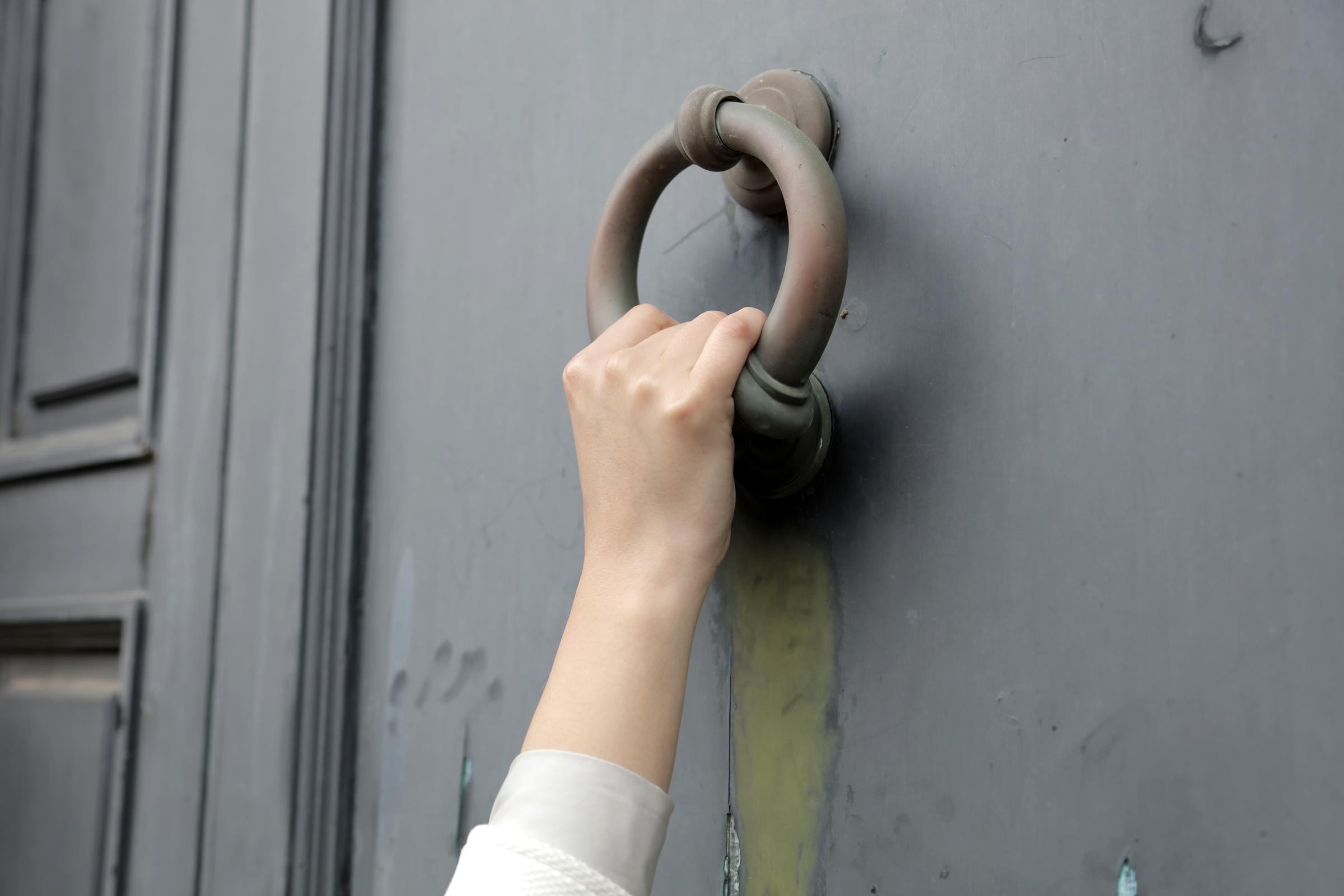 A hand knocking on a door | Source: Freepik