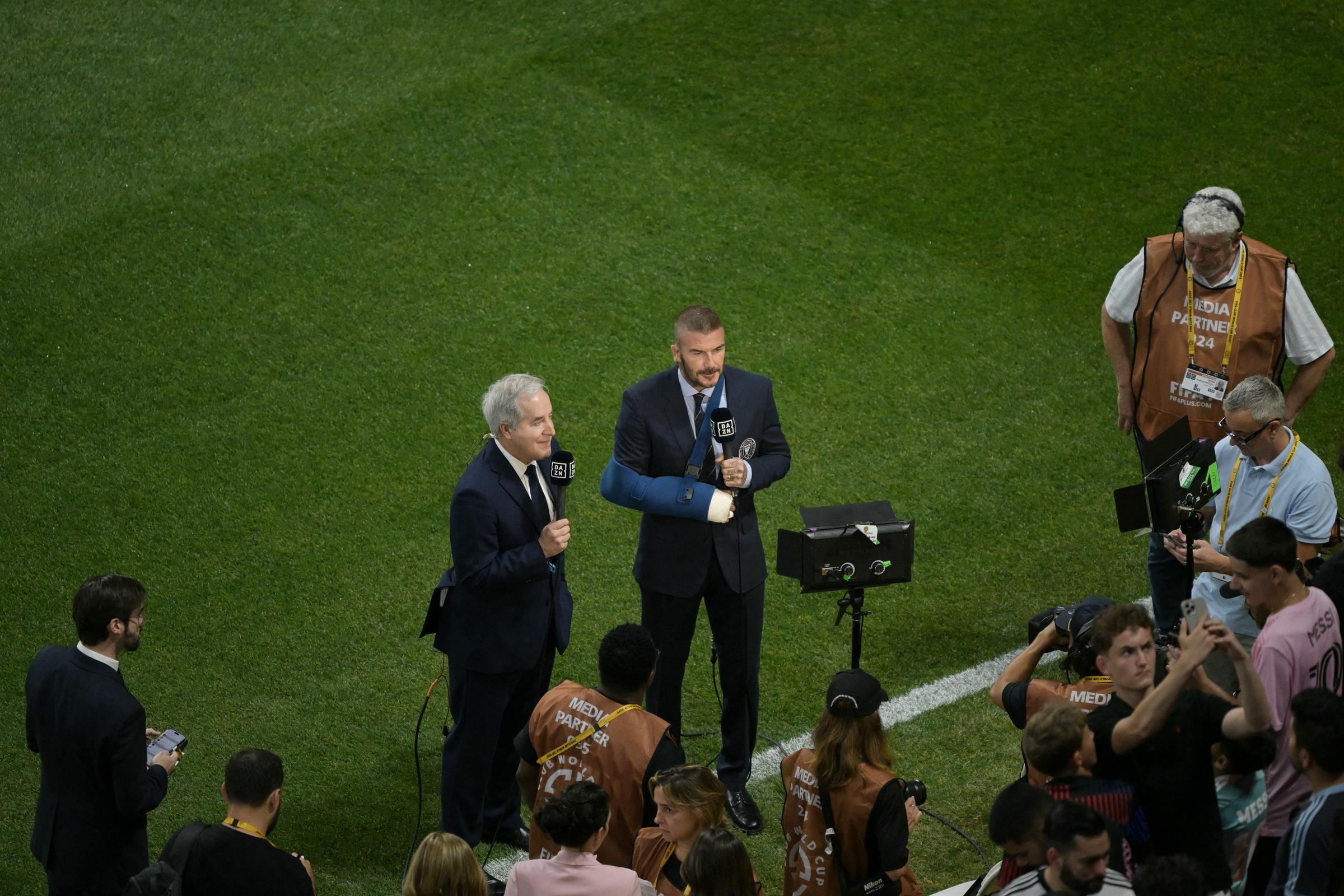 David Beckham joins Jorge Mas on the field at Mercedes-Benz Stadium, June 29, 2025. With his bandaged arm in full view, Beckham stands confidently as he engages with the media before Inter Miami's high-stakes match