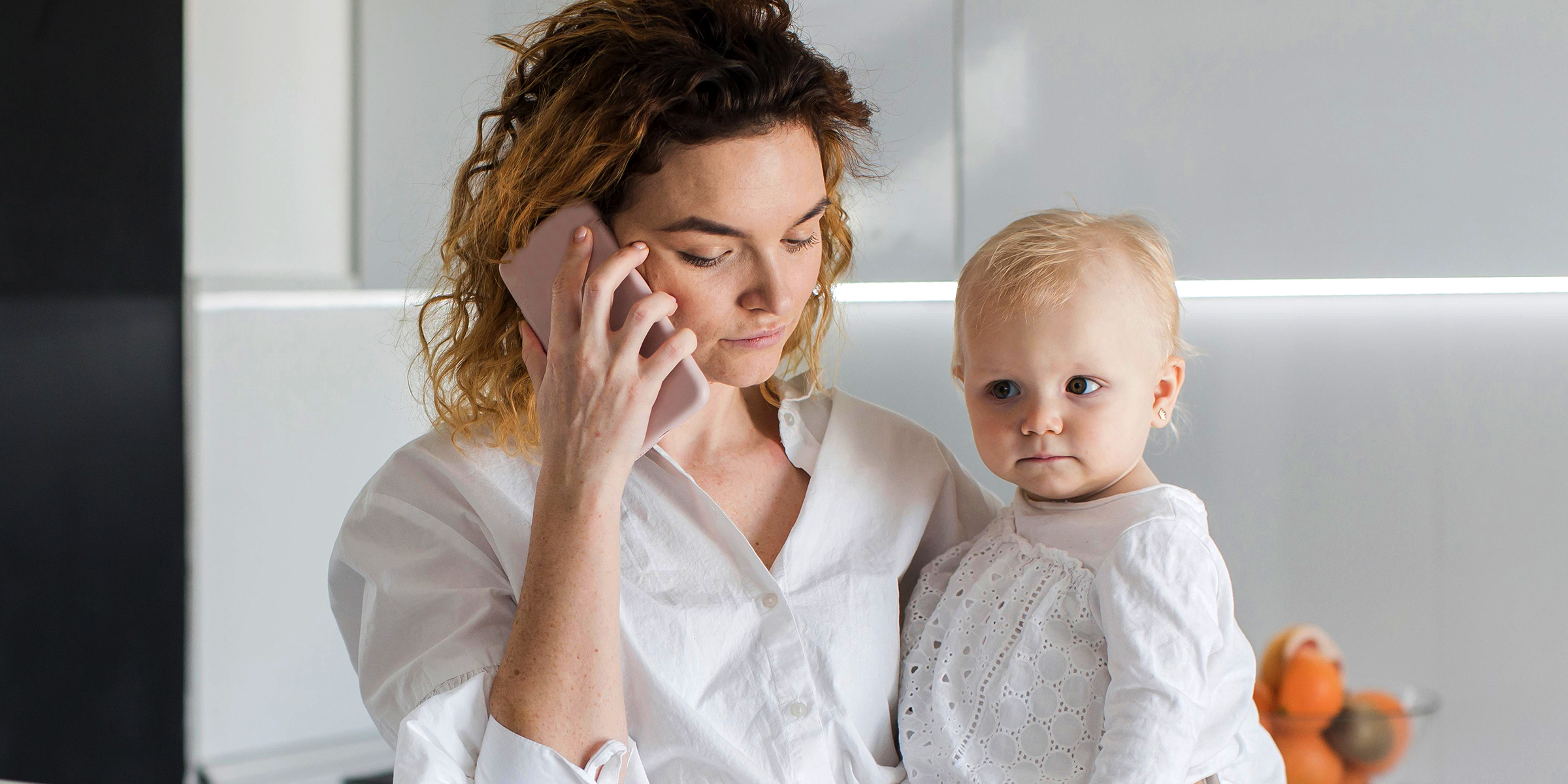 A woman with a baby talking on the phone | Source: Freepik