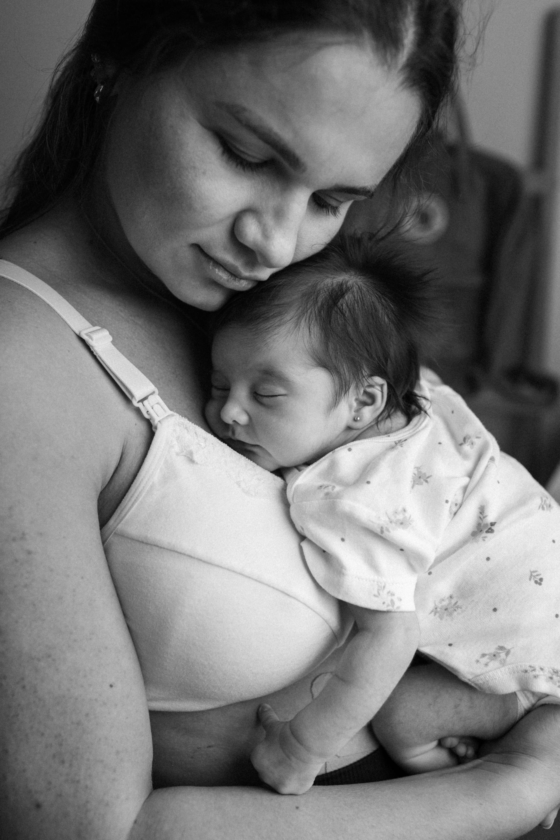 A mother hugging her sleeping baby | Source: Pexels