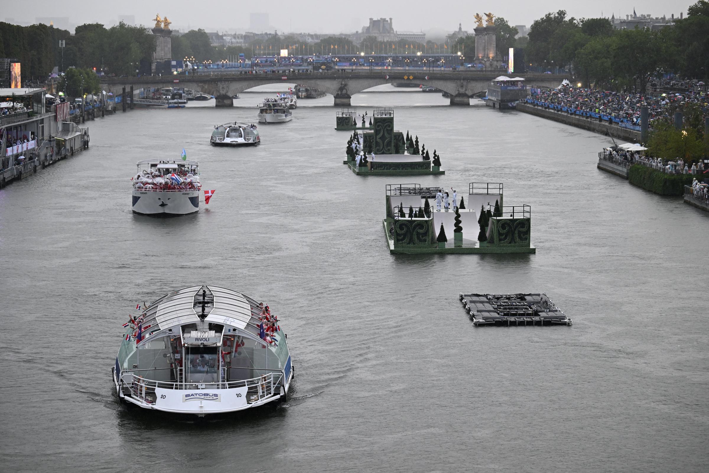 Boats carrying members of delegations sail along the Seine during the opening ceremony of the Paris 2024 Olympic Games in Paris, France, on July 26, 2024. | Source: Getty Images