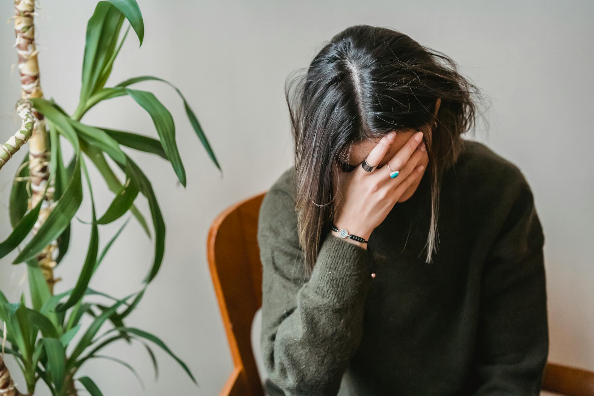 A woman covering her face with her hands | Source: Pexels