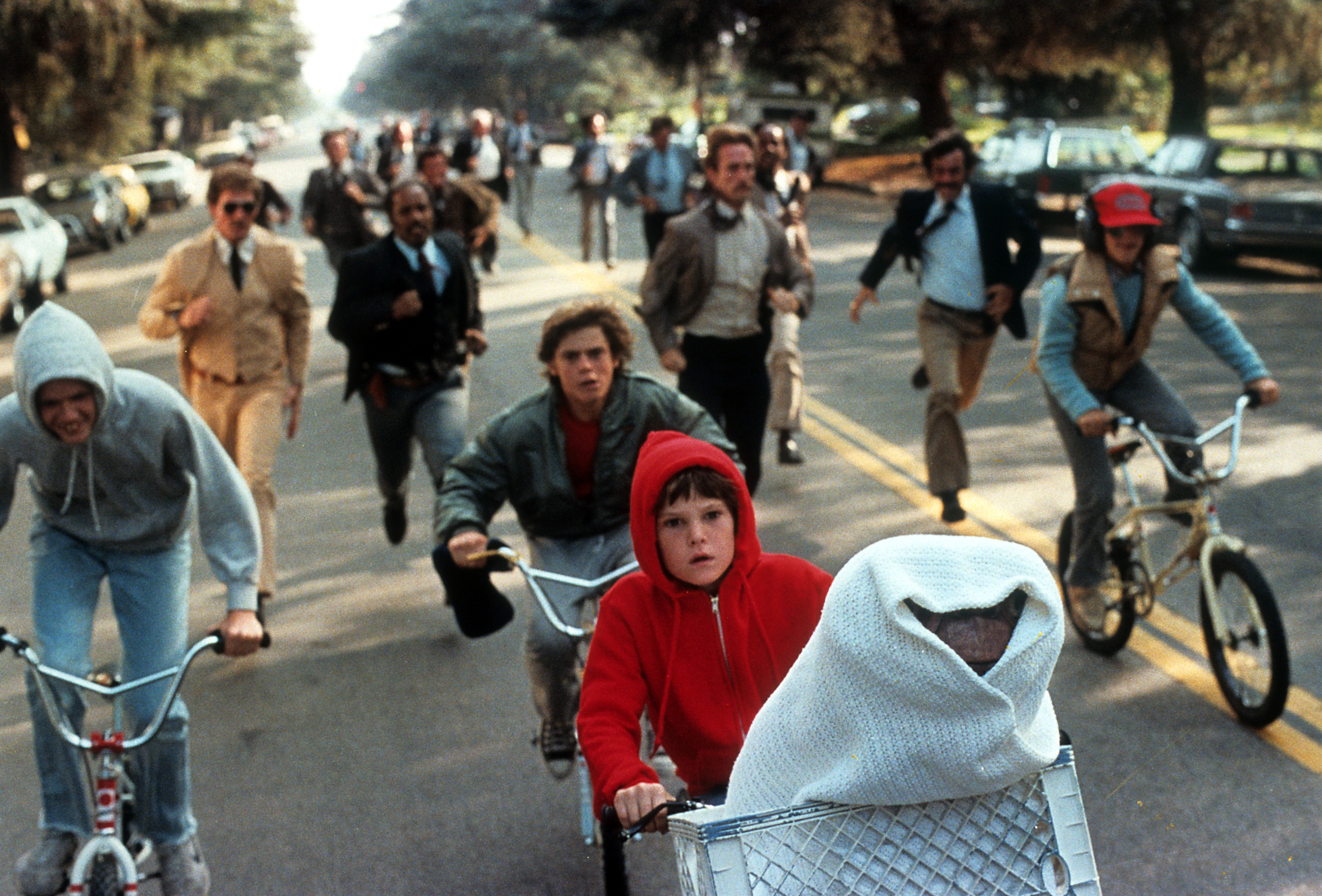 Henry Thomas is pictured riding with E.T. in his bike in a scene from the film, 'E.T. The Extra-Terrestrial', in 1982 | Source: Getty Images