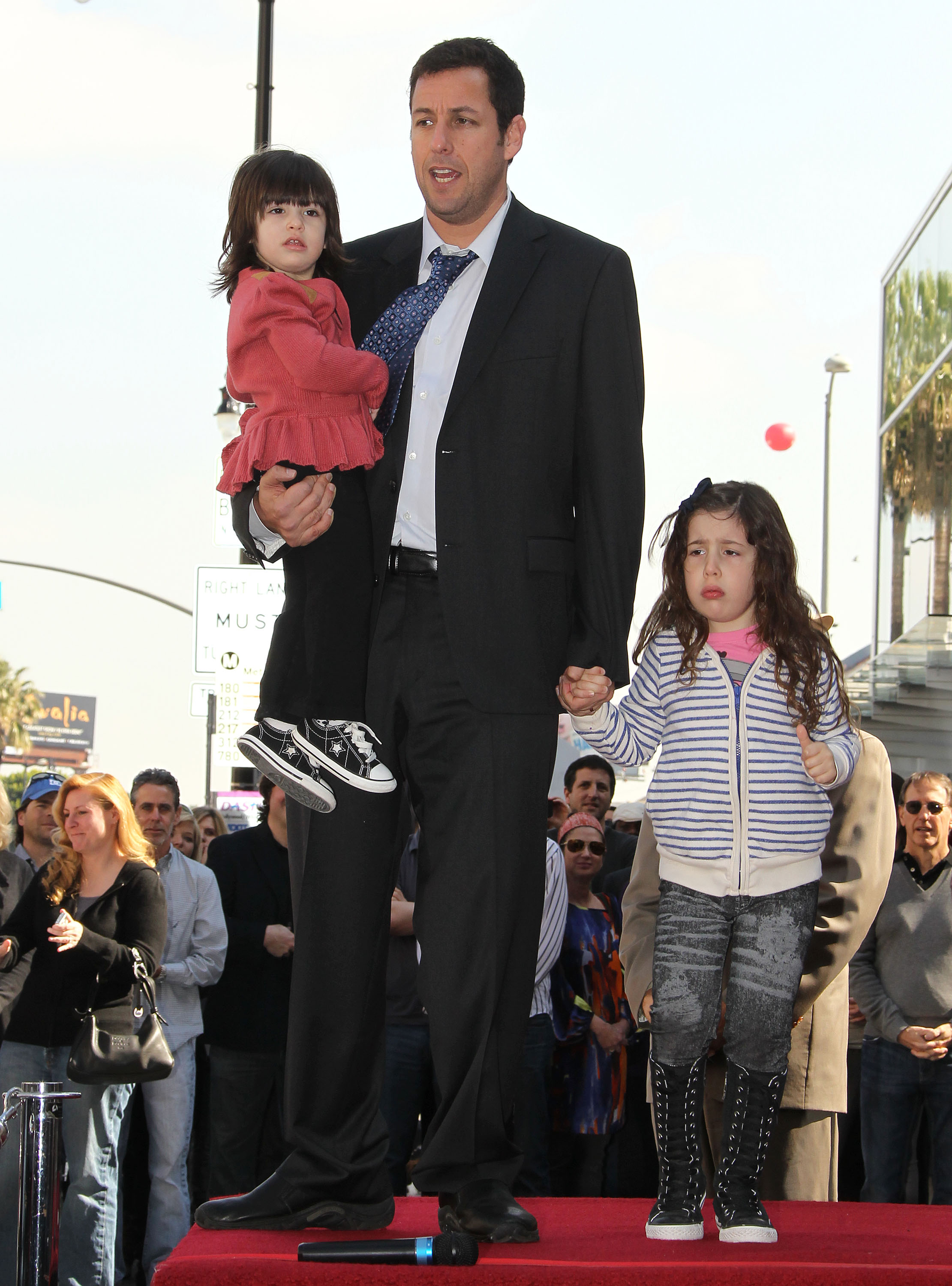 Adam Sandler and his children Sadie and Sunny in Hollywood, California on February 1, 2011 | Source: Getty Images